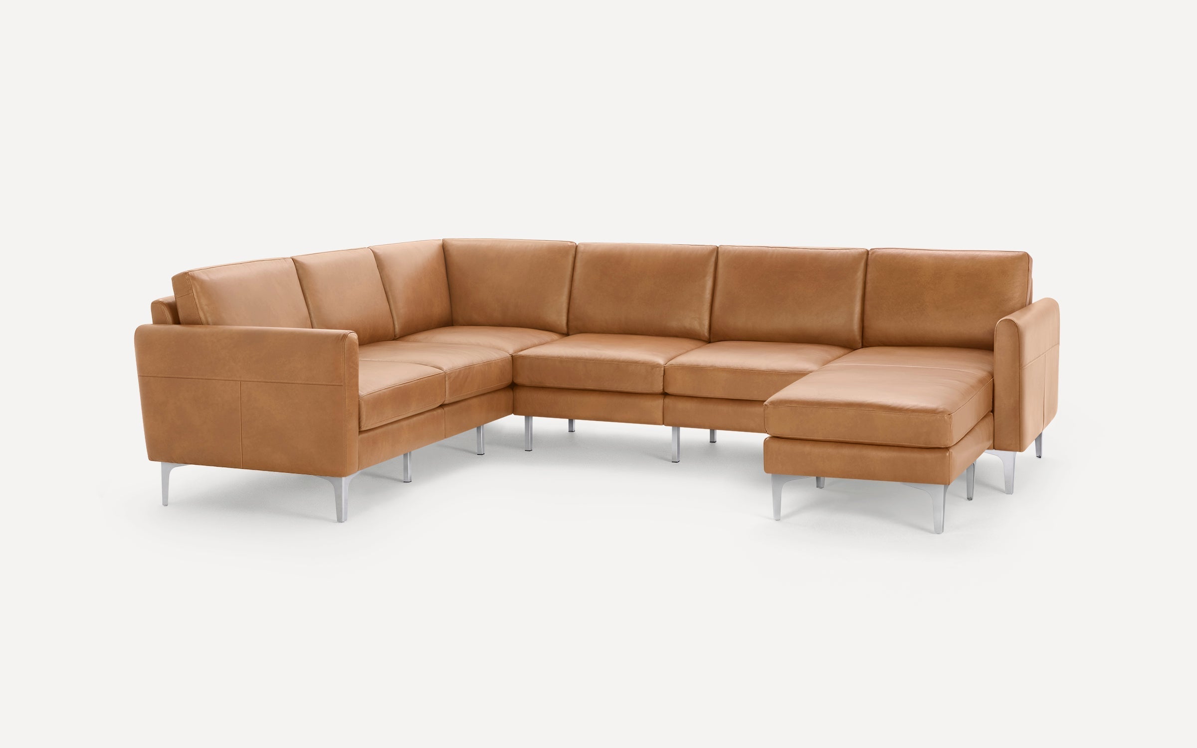 Modern L-shaped sectional sofa in tan leather upholstery with clean lines and metal legs, designed for spacious seating.