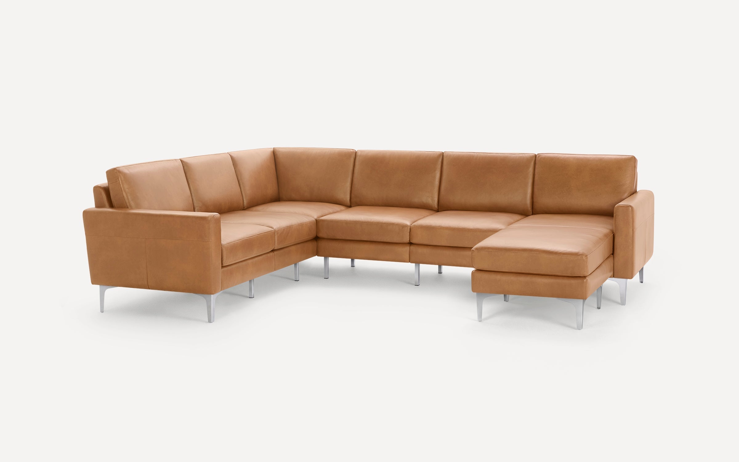 Modern L-shaped sectional sofa with sleek, caramel brown leather upholstery and slim silver metal legs on a white background.