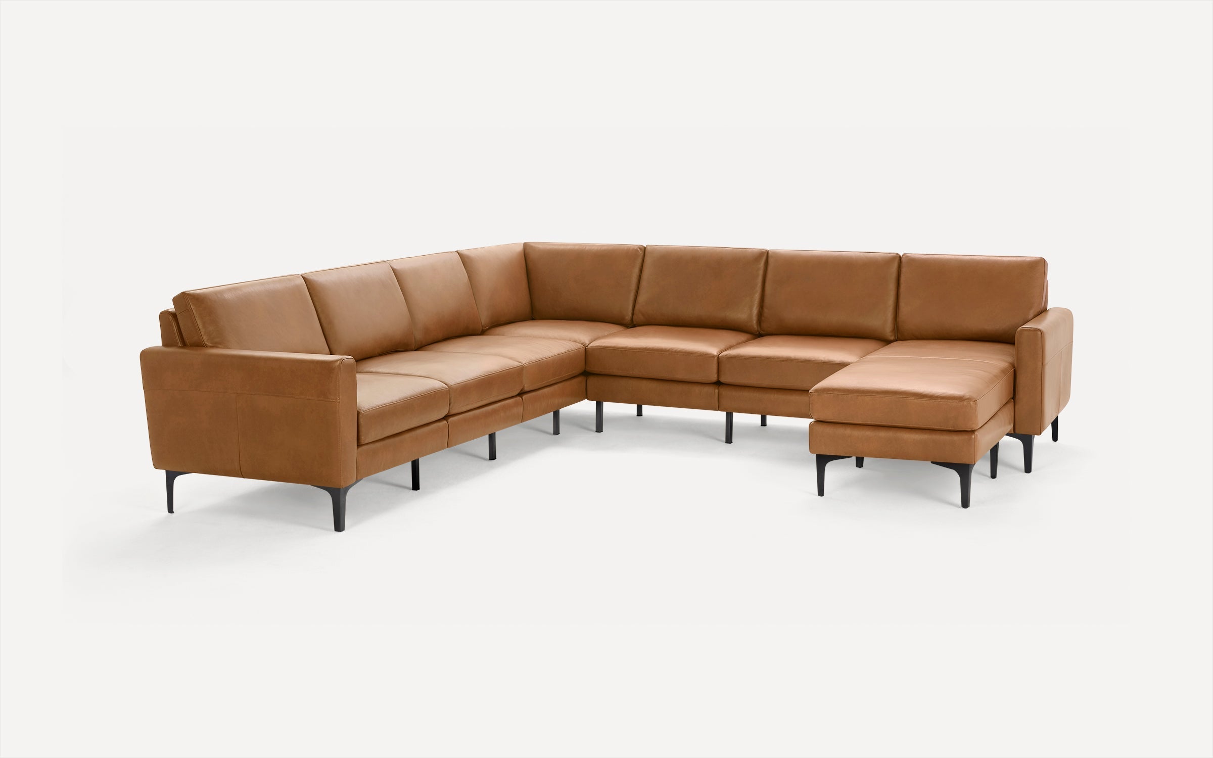 Modern L-shaped sectional sofa in light brown leather with slim black metal legs and clean, minimalist design.