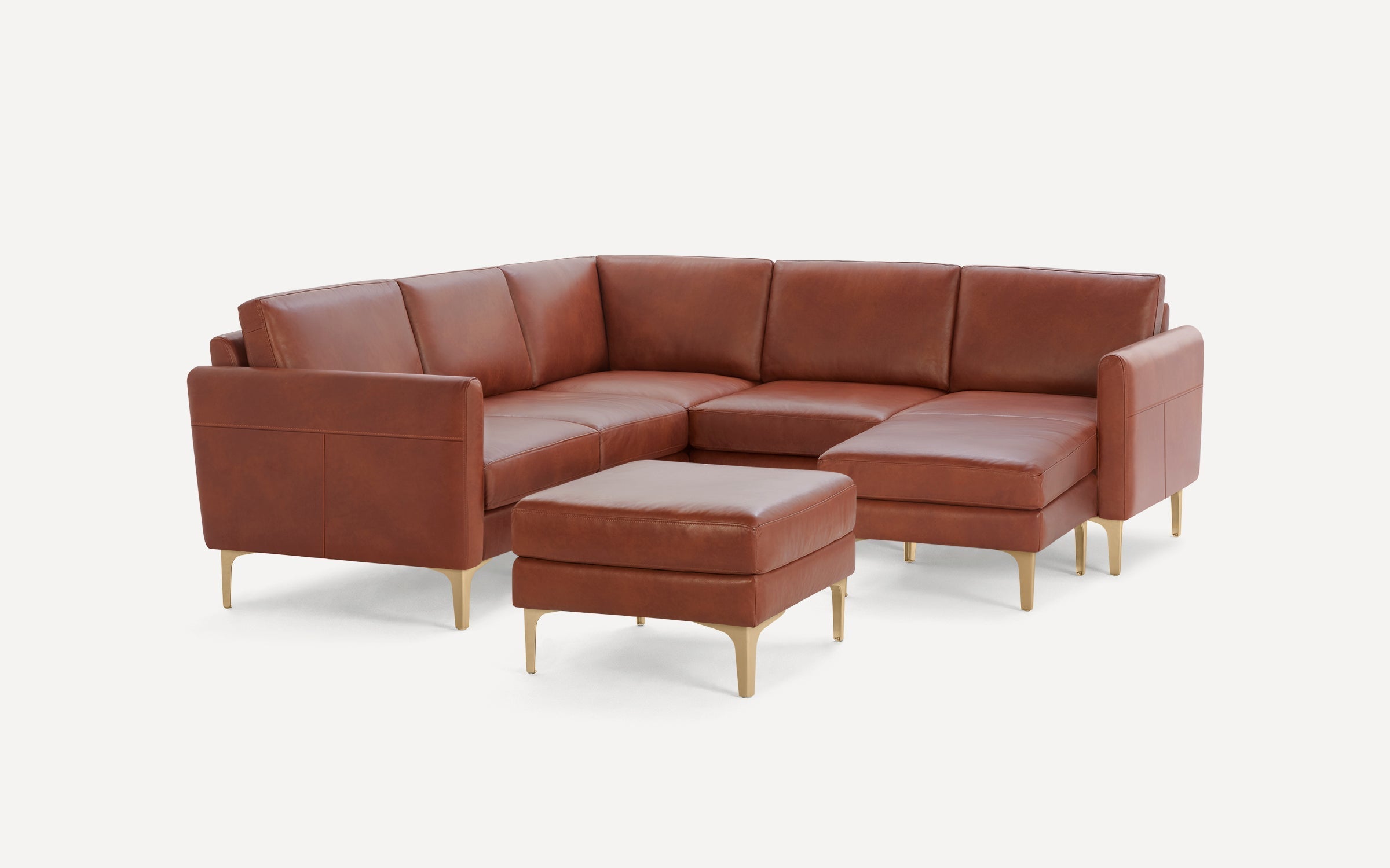 Modern L-shaped brown leather sectional sofa with matching ottoman and gold metal legs, elegant and minimalist design.