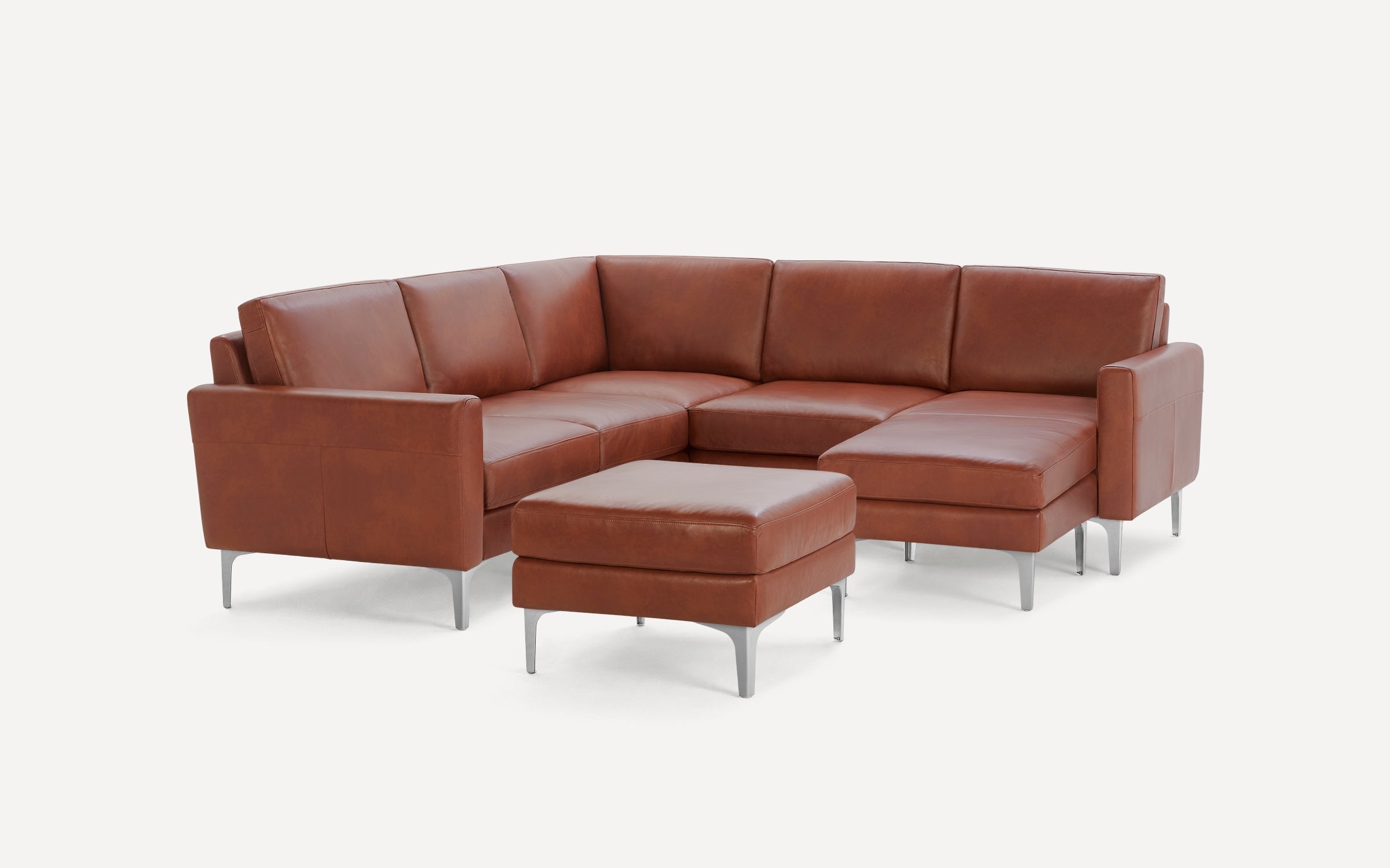 Modern L-shaped sectional sofa in brown leather with matching square ottoman and sleek silver metal legs.