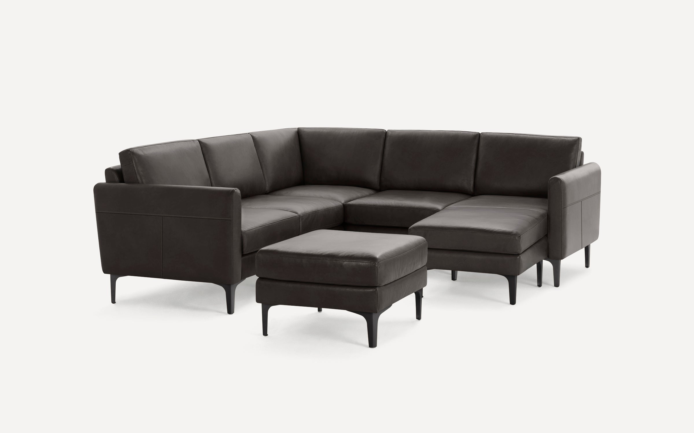 Dark brown leather L-shaped sectional sofa with matching ottoman, sleek metal legs, and clean modern design.