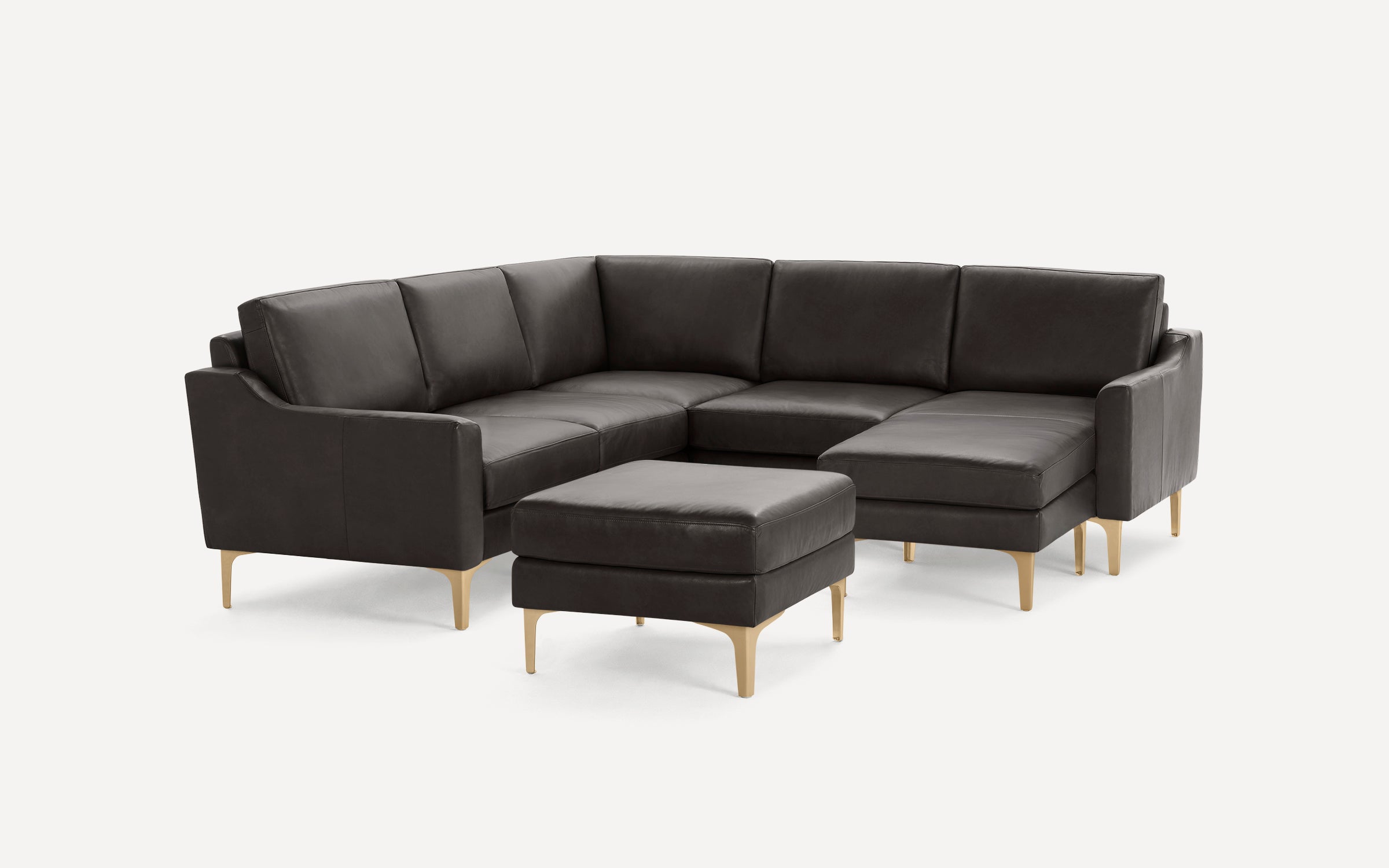Dark brown leather sectional sofa with clean lines and light wooden legs, accompanied by a matching ottoman.