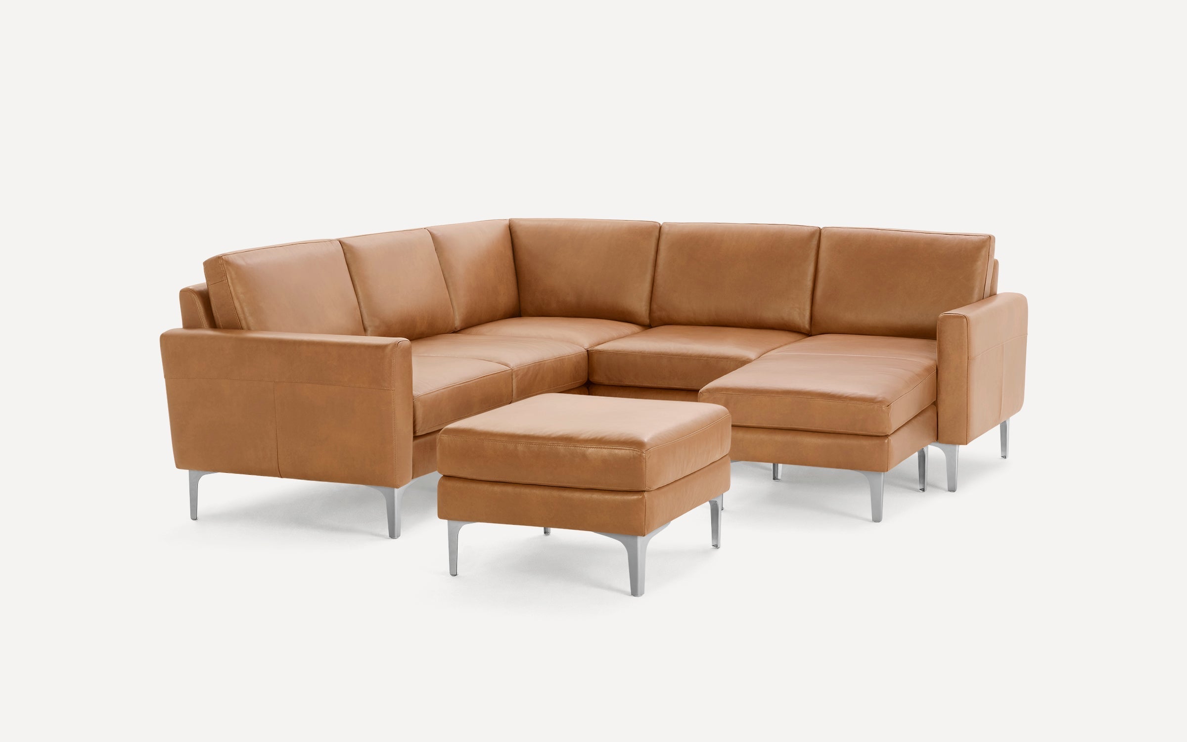 Modern L-shaped tan leather sectional sofa with clean lines, metal legs, and a matching ottoman on a white background.