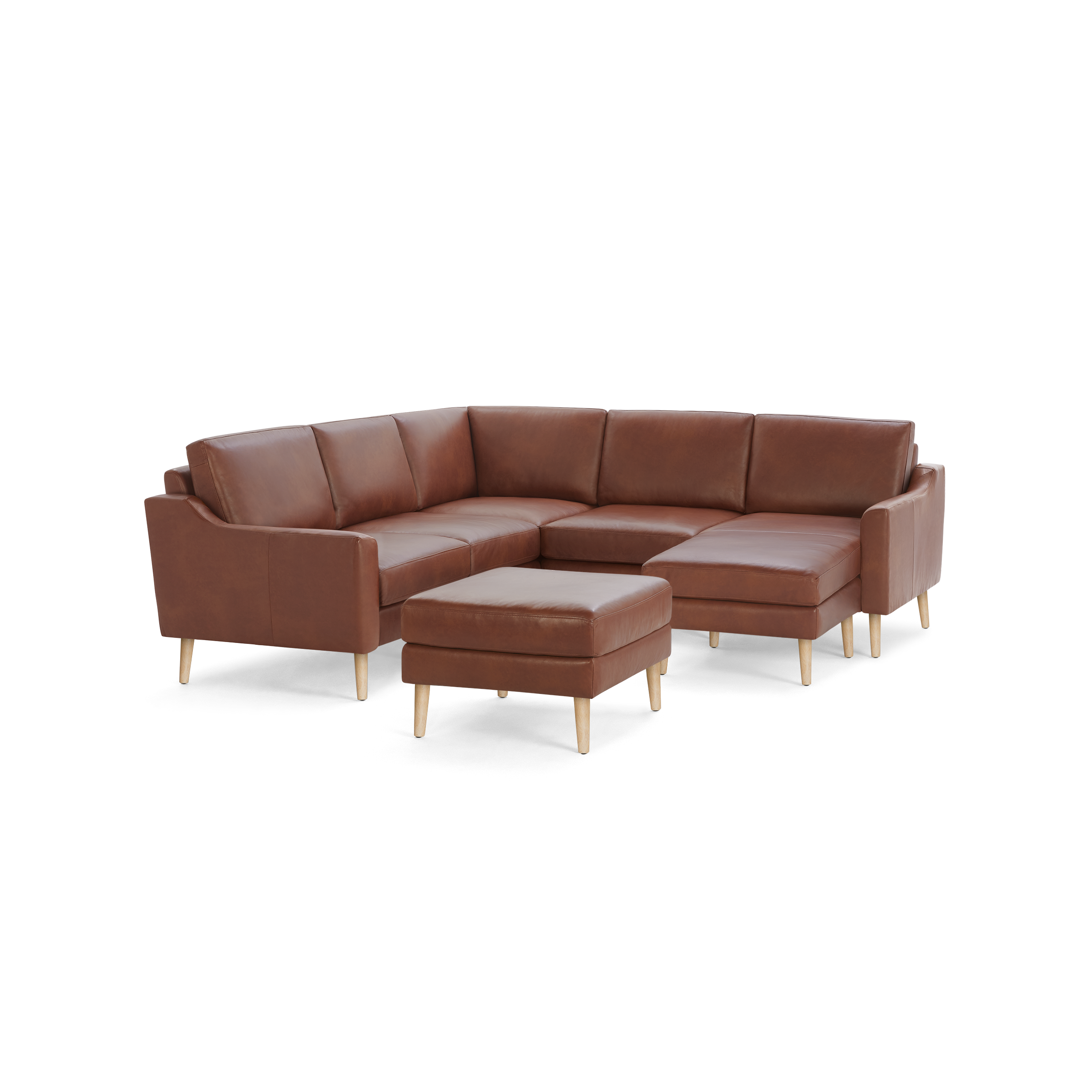 Brown leather L-shaped sectional sofa with wooden legs and a matching ottoman, modern and minimalist design.