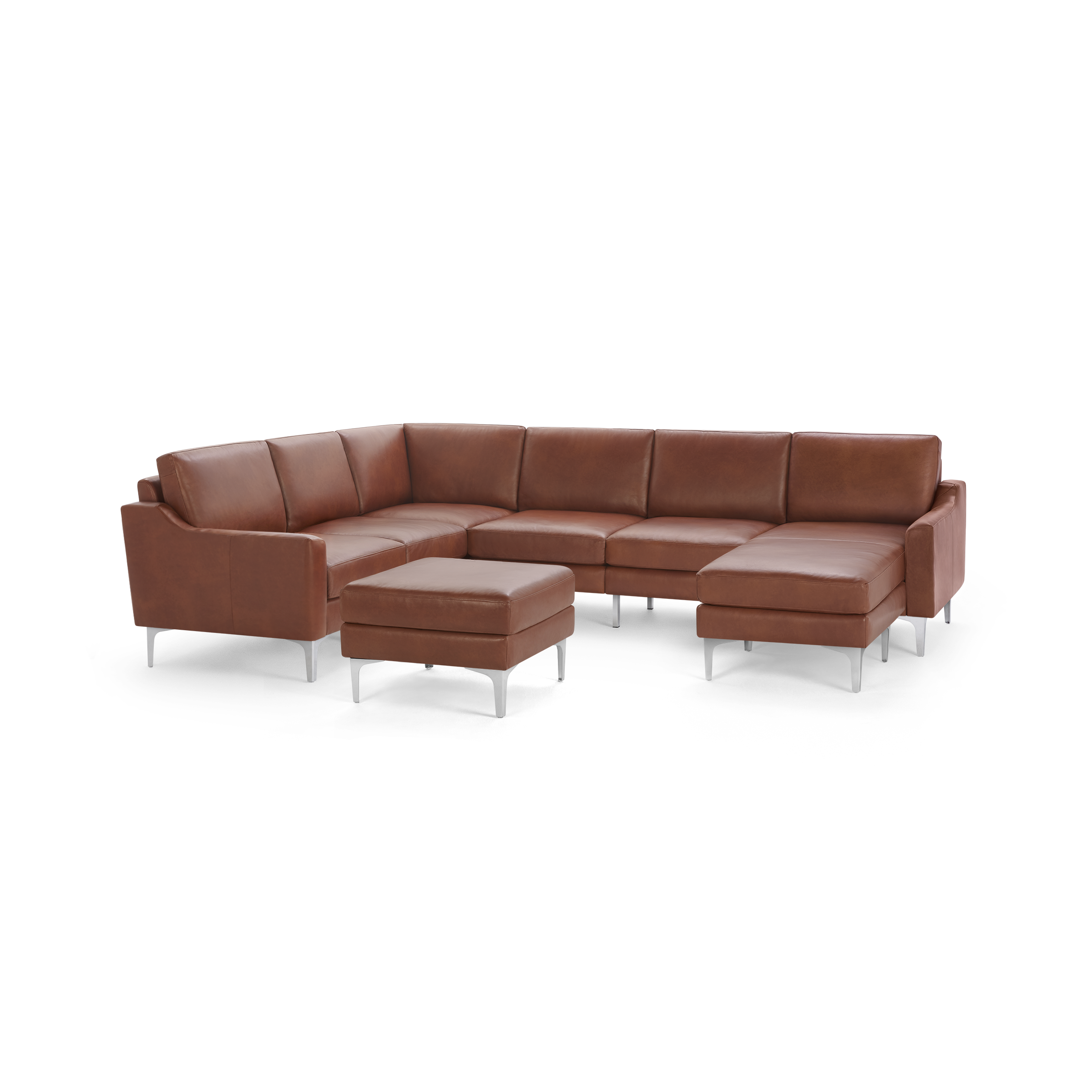 Large brown leather sectional sofa with metal legs, including a matching ottoman.