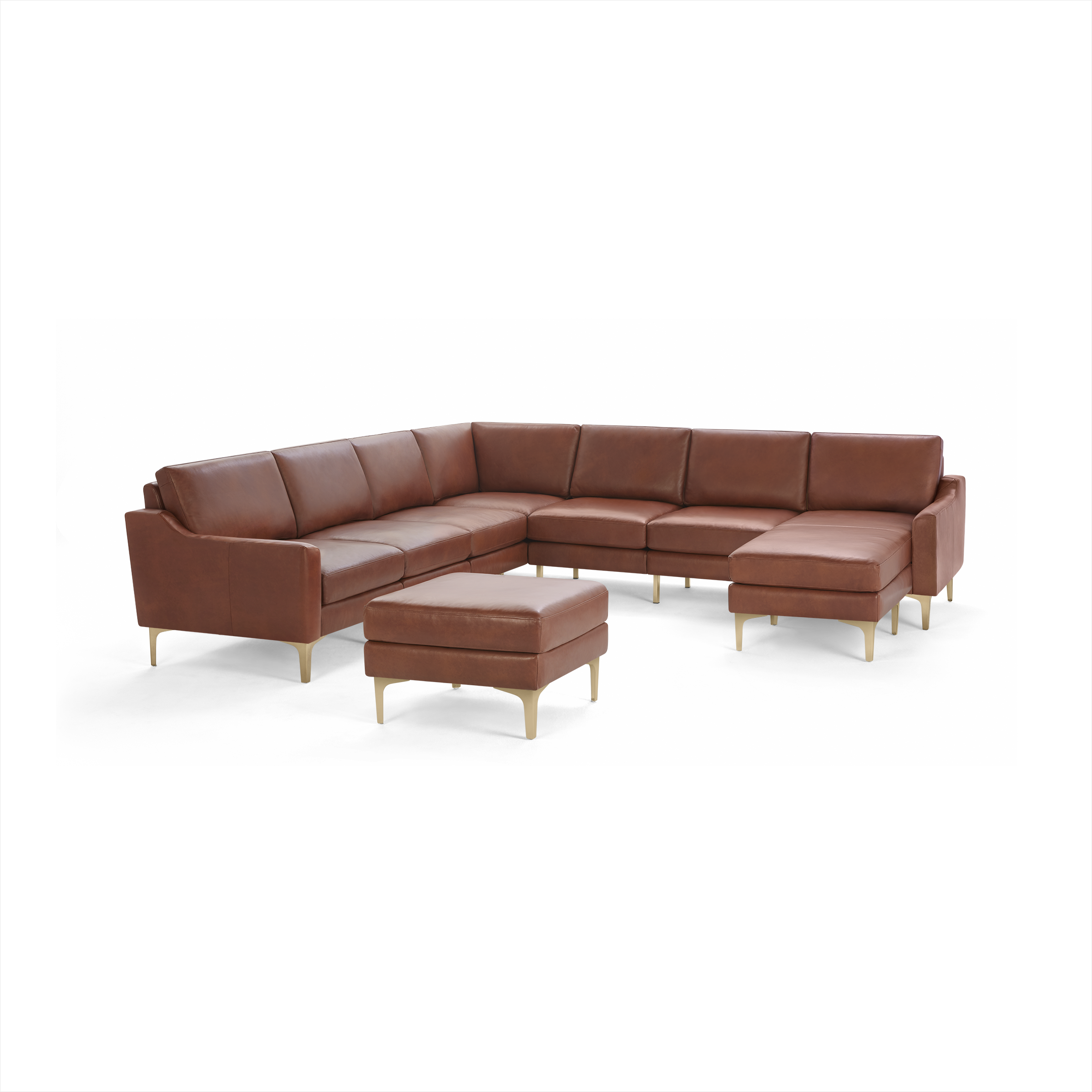 Brown leather sectional sofa with clean lines and light wood legs, including a matching ottoman.