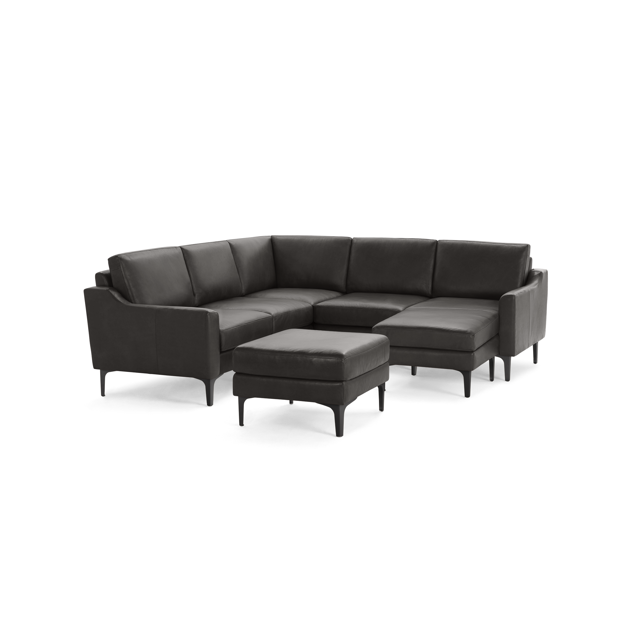 Dark gray leather L-shaped sectional sofa with slim armrests and matching ottoman on black legs.