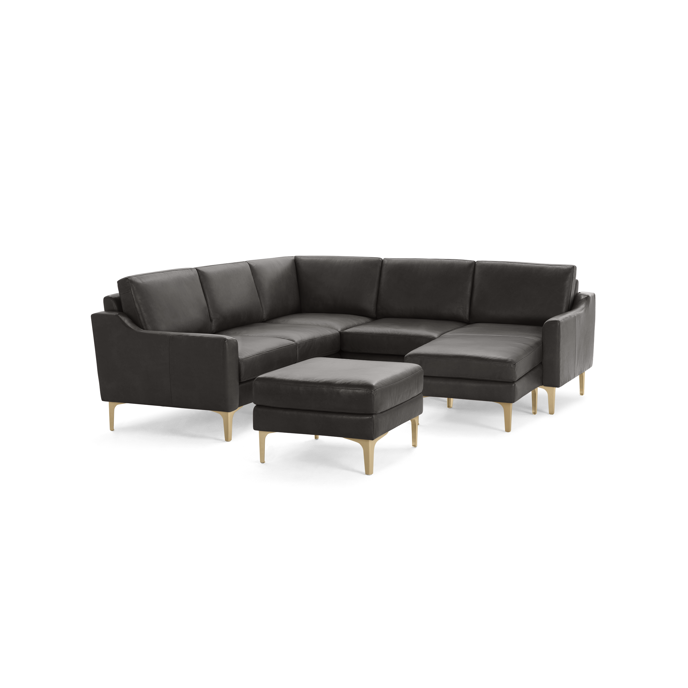 Dark gray sectional sofa with matching ottoman, sleek cushioning, and light wooden legs on a plain background.