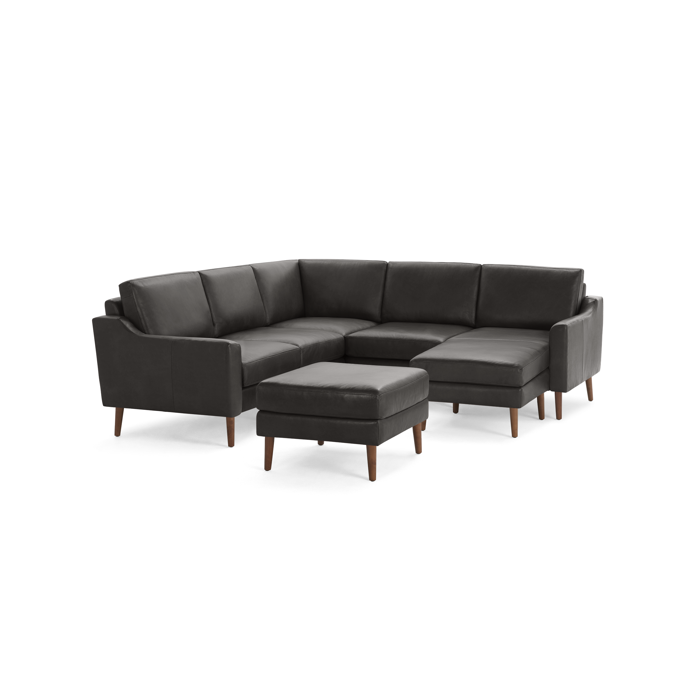 Dark gray leather sectional sofa with wooden legs, featuring a cushioned ottoman and modern, clean-lined design.