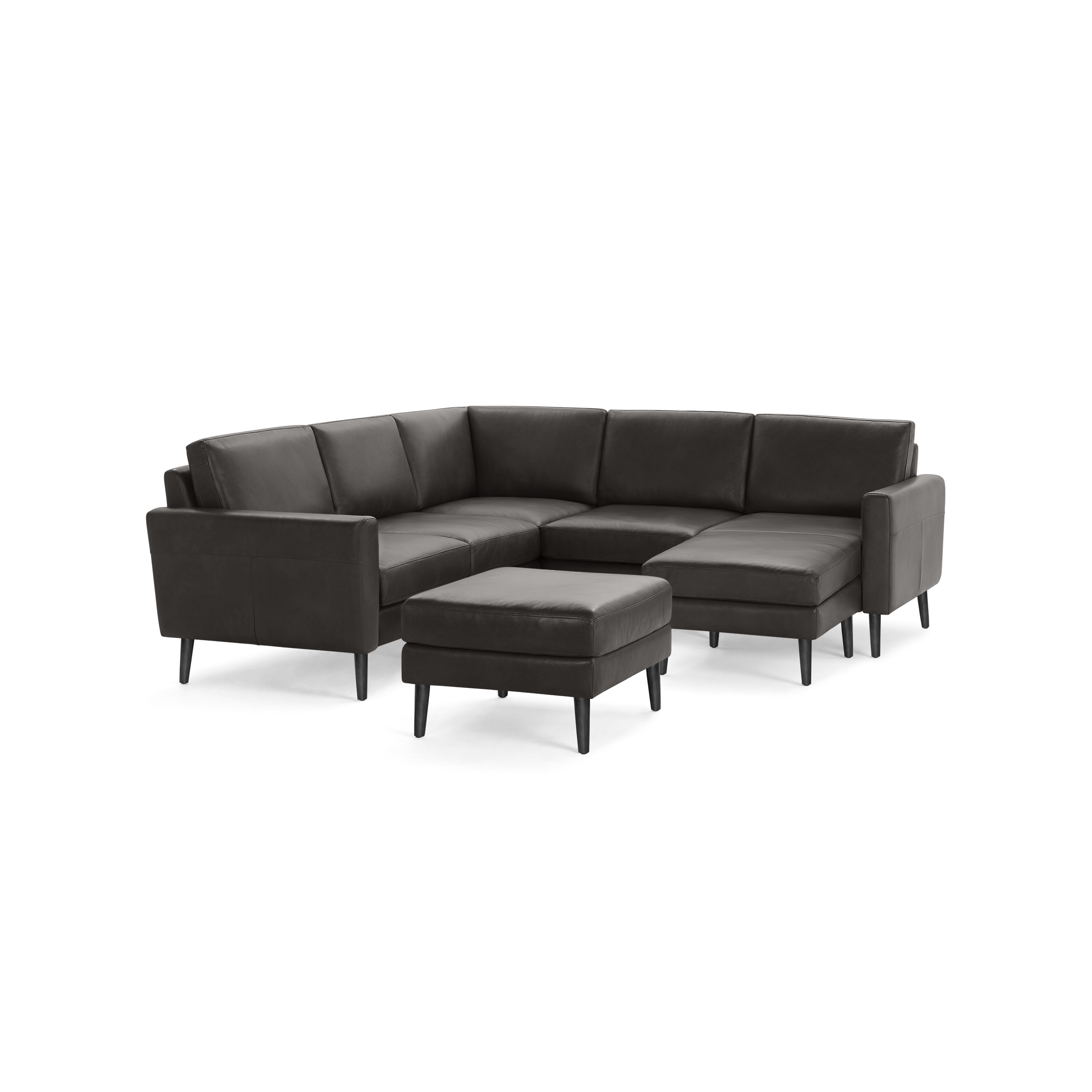 Dark gray leather L-shaped sectional sofa with clean lines and matching ottoman on black tapered legs.