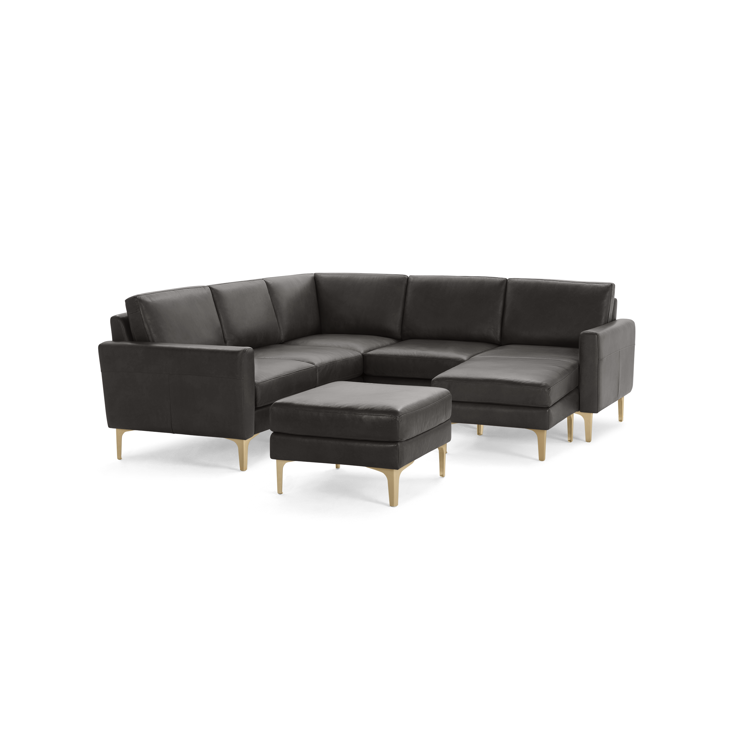 Dark gray L-shaped sectional sofa with matching ottoman, cushioned seats, and light wooden legs on a black background.