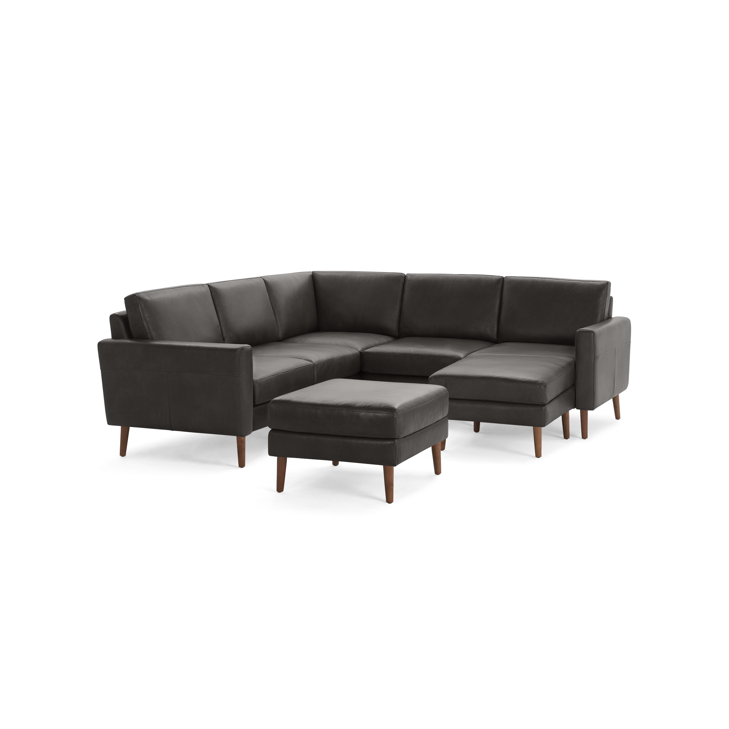 Modern dark gray leather sectional sofa with wooden legs and matching ottoman, offering comfortable seating and stylish design.