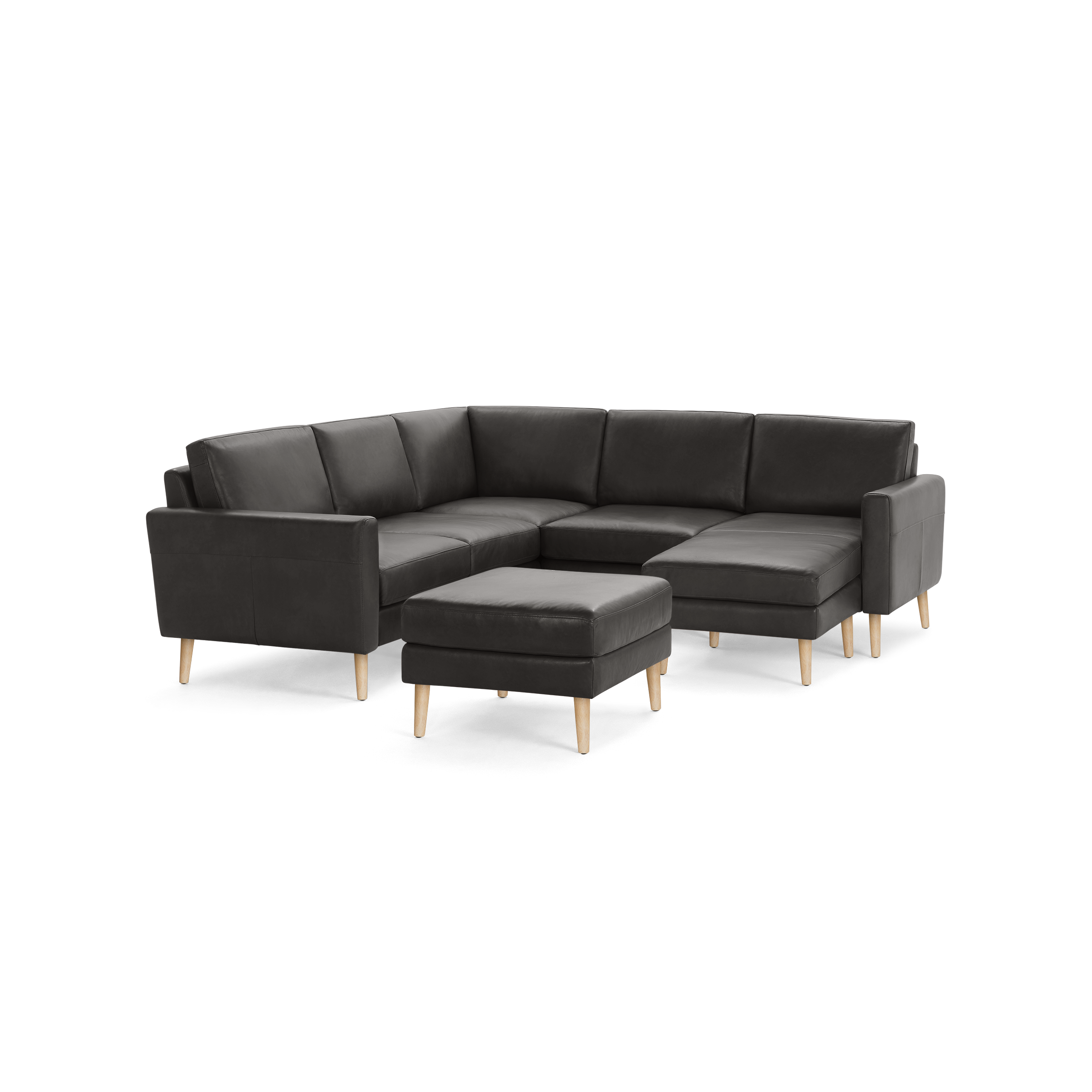 Dark gray sectional sofa with wooden legs and matching ottoman, featuring clean lines and modern design.