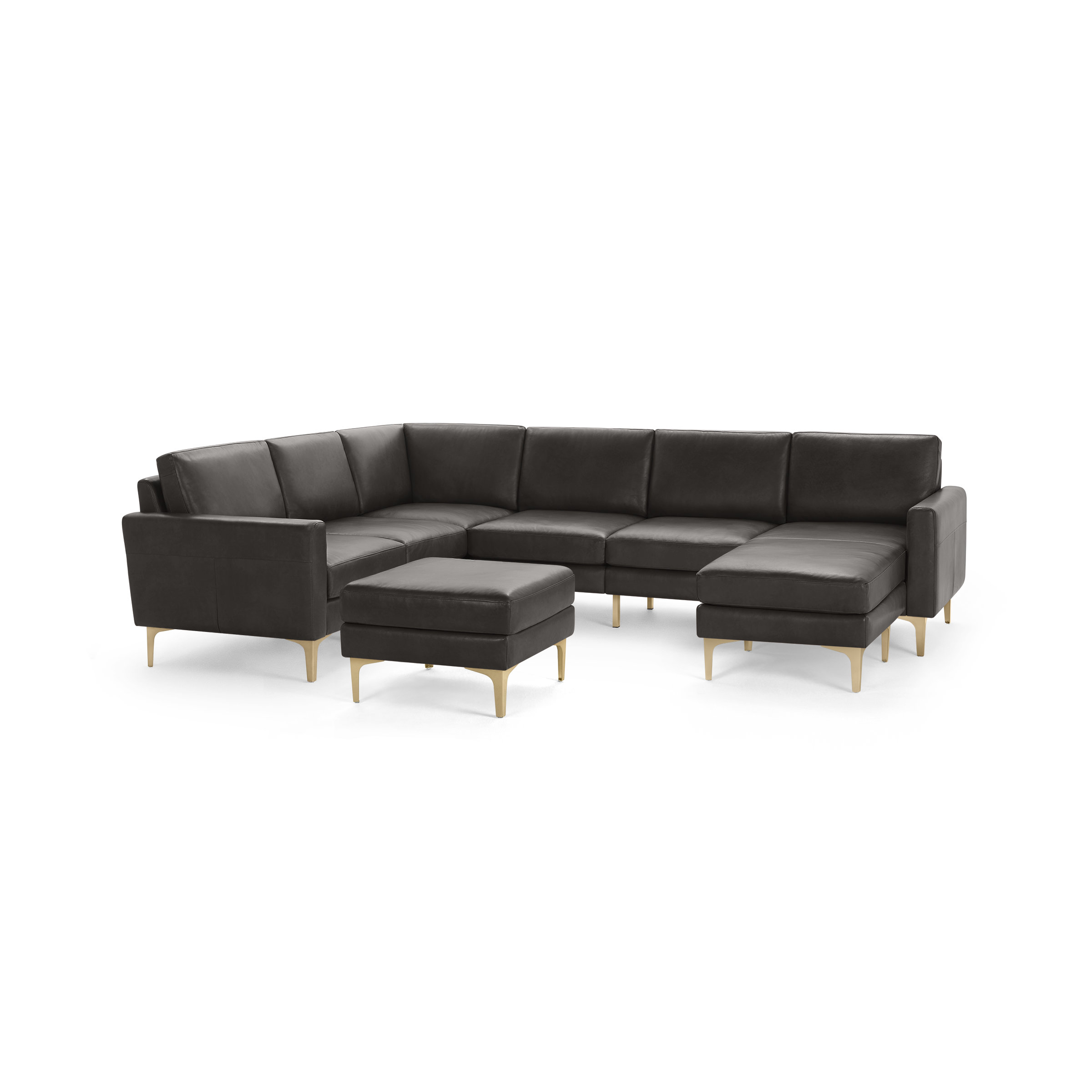 Dark gray leather sectional sofa with chaise lounge and matching ottoman, featuring light wooden legs, modern design.