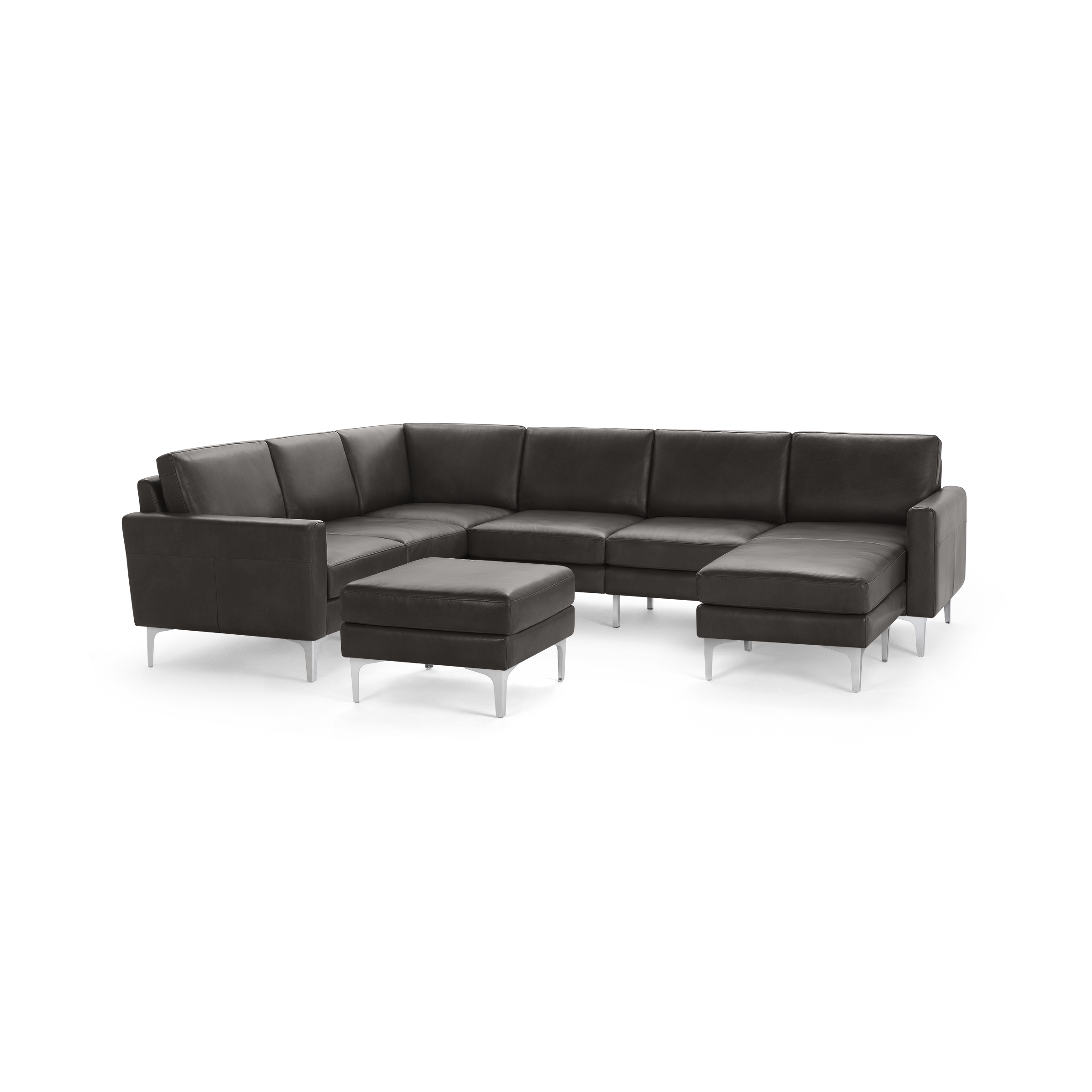 Dark gray leather sectional sofa with a matching ottoman, featuring clean lines and metal legs.