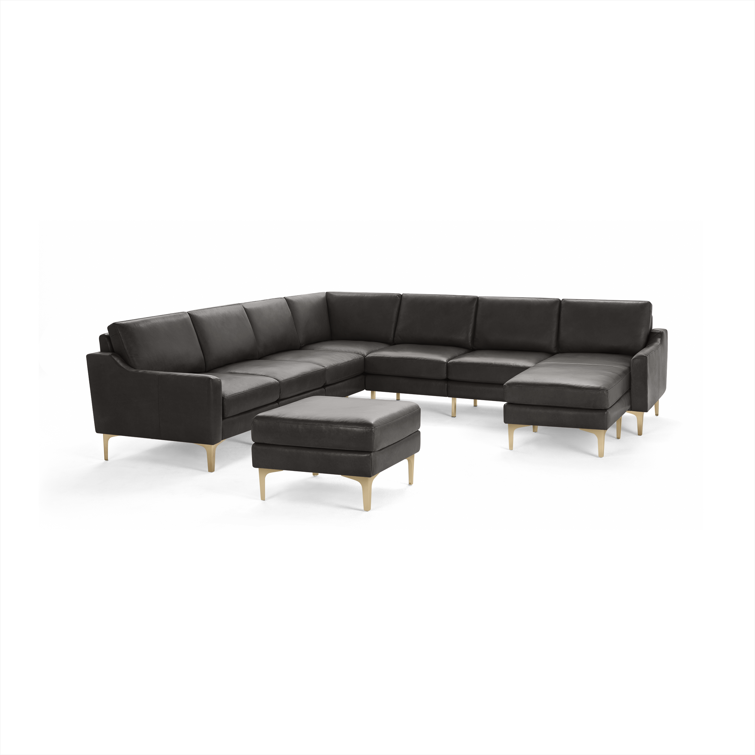 Modern black leather sectional sofa with matching ottoman, featuring sleek gold metal legs and clean, minimalist design.
