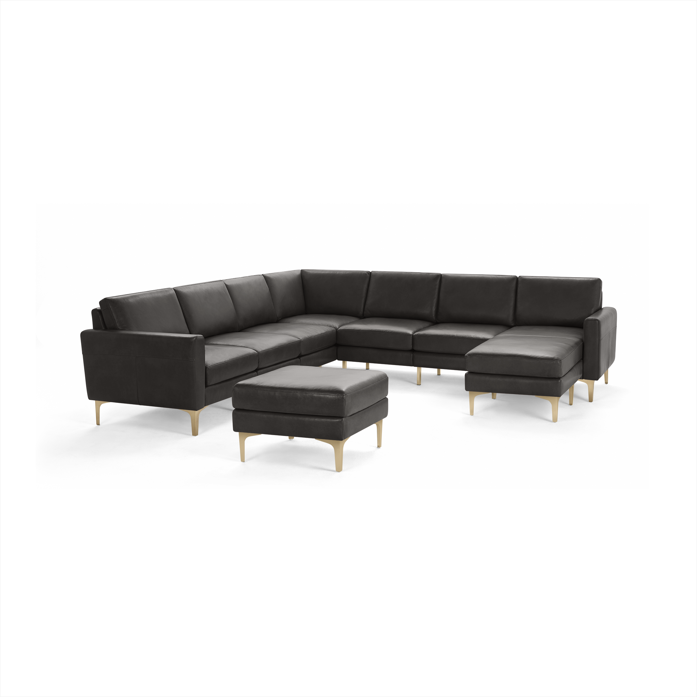Modern L-shaped sectional sofa in dark gray leather with gold-toned legs and matching ottoman, offering ample seating and style.