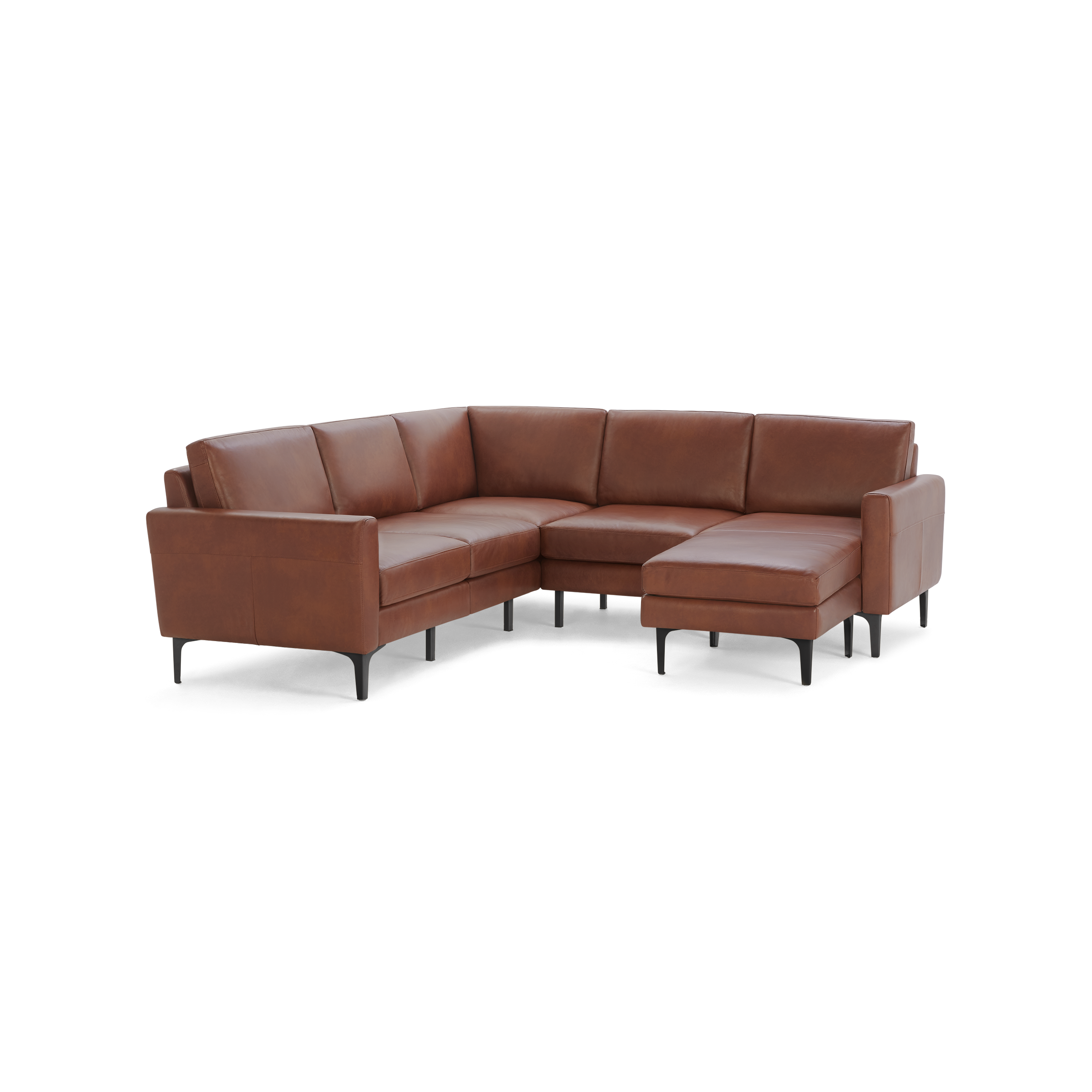 Modern sectional sofa in warm brown leather with clean lines, slim black legs, and a chaise lounge on the right side.