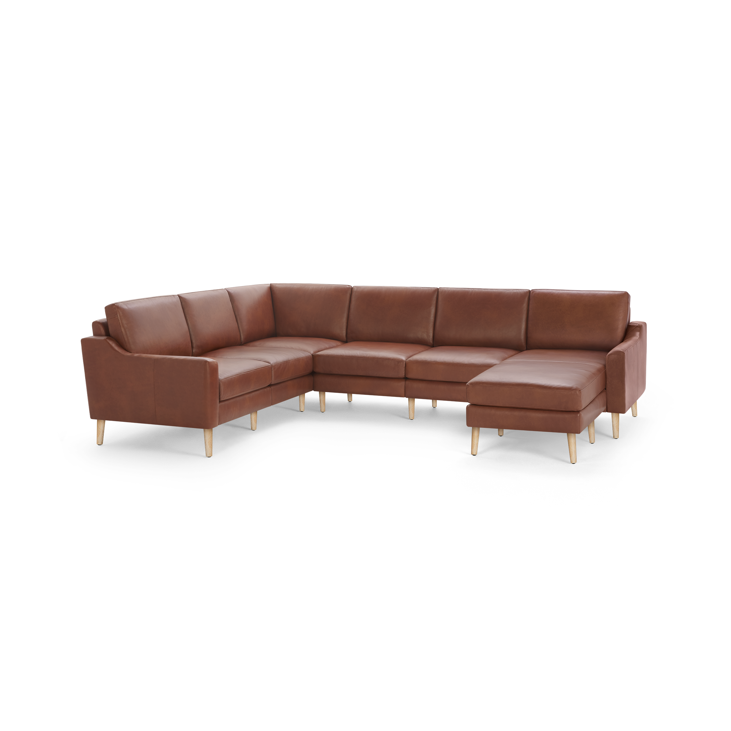 Large brown leather sectional sofa with wooden legs, featuring multiple cushions and a chaise lounge on the right side.