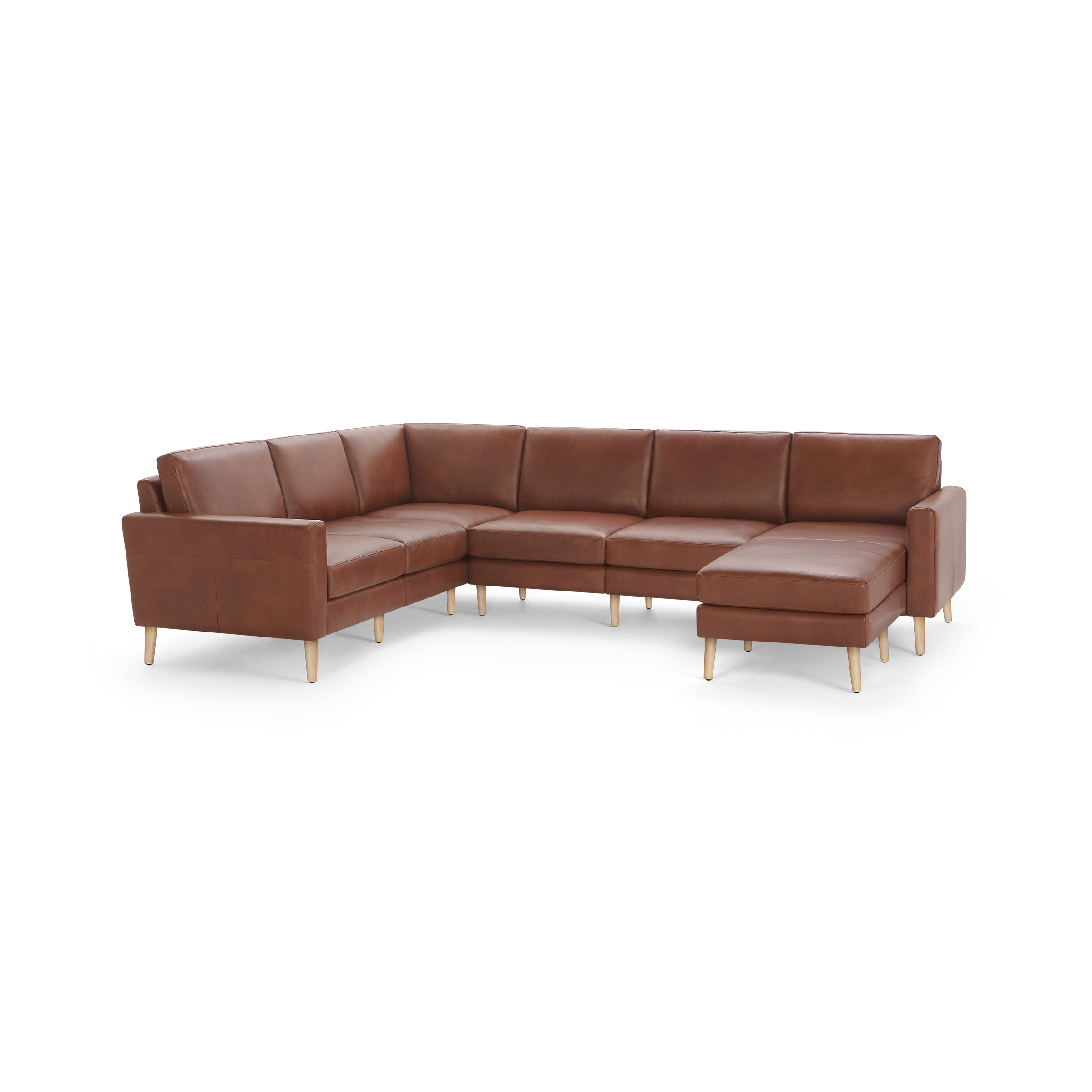 Large L-shaped sectional sofa with brown leather upholstery and light wooden legs, featuring cushioned seats and backrests.