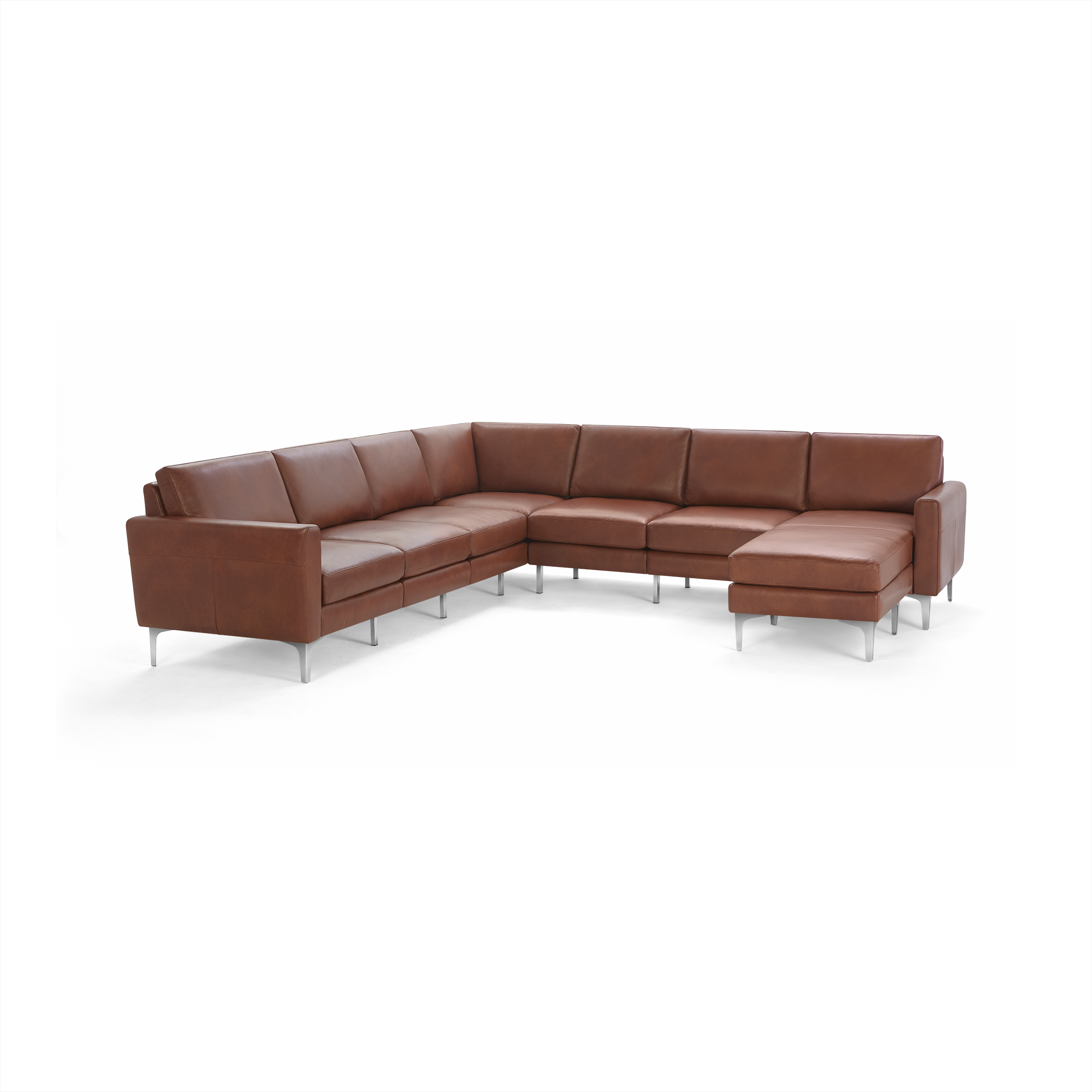 Large modern L-shaped sectional sofa in brown leather with metal legs and cushioned seats and backs.
