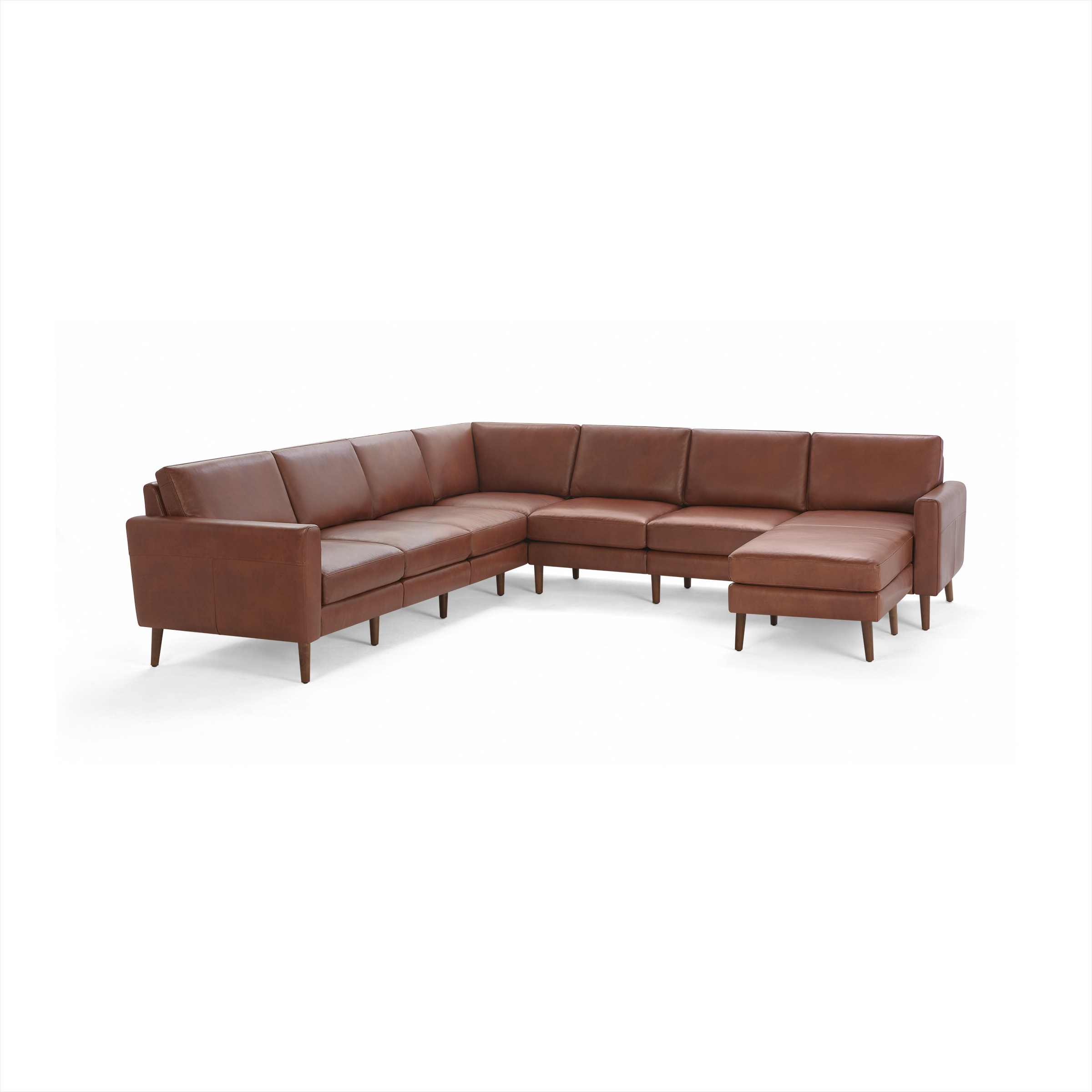 Large L-shaped sectional sofa with smooth brown leather upholstery and wooden tapered legs, featuring cushioned seats and backrests.