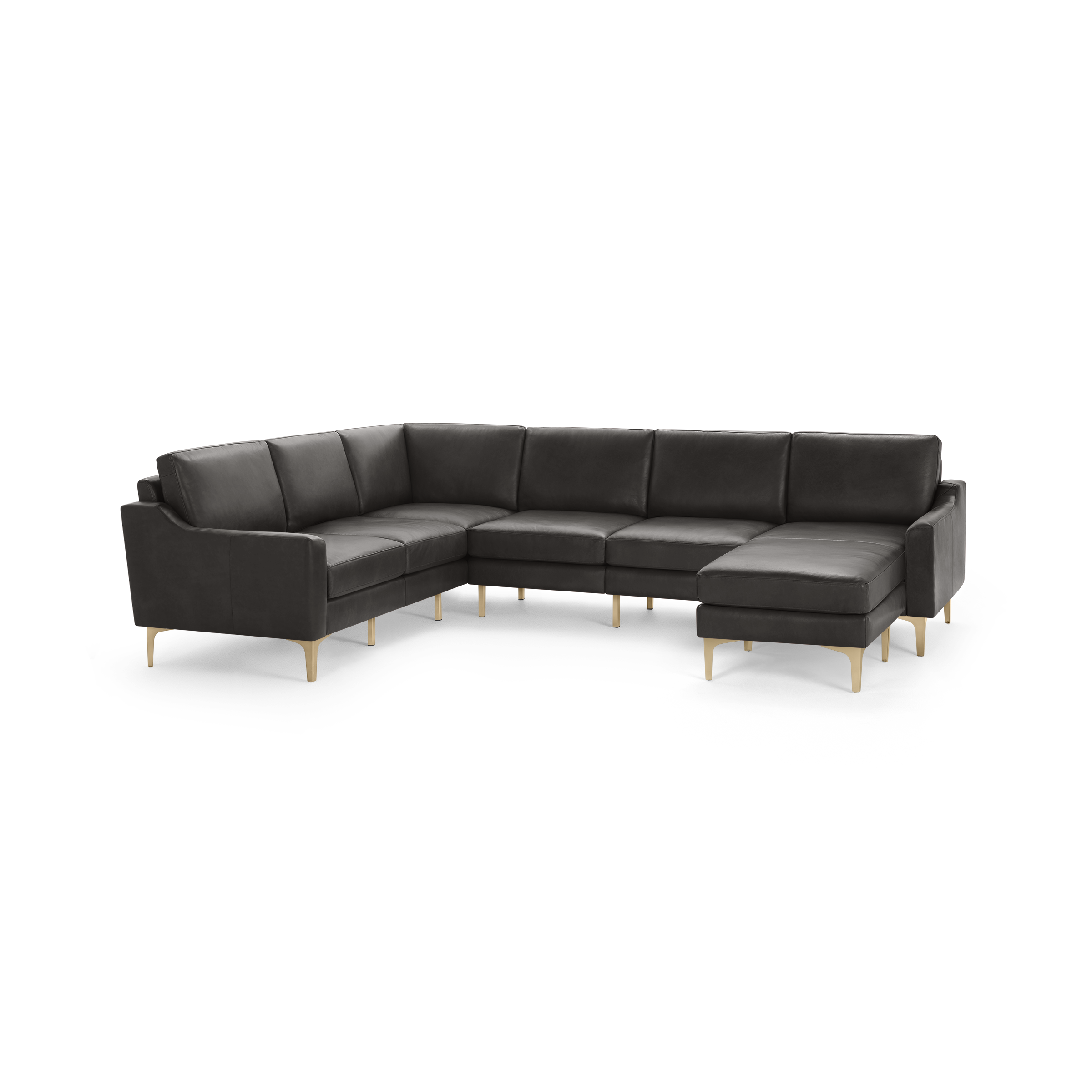Modern dark gray sectional sofa with angled arms, plush cushions, and light wooden legs on a black background.