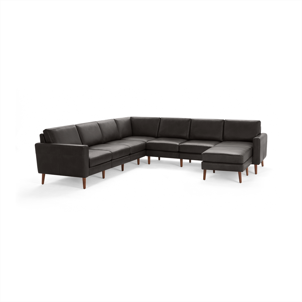 Modern dark gray leather L-shaped sectional sofa with wooden legs and cushioned seats and backrests.