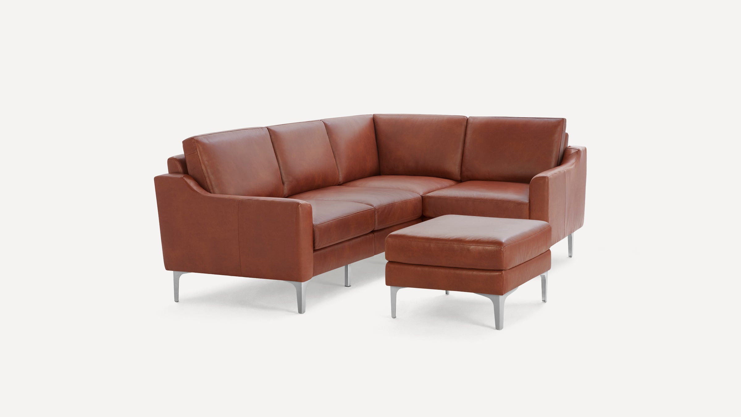 Brown leather sectional sofa with matching ottoman, featuring sleek metal legs and modern, clean lines.