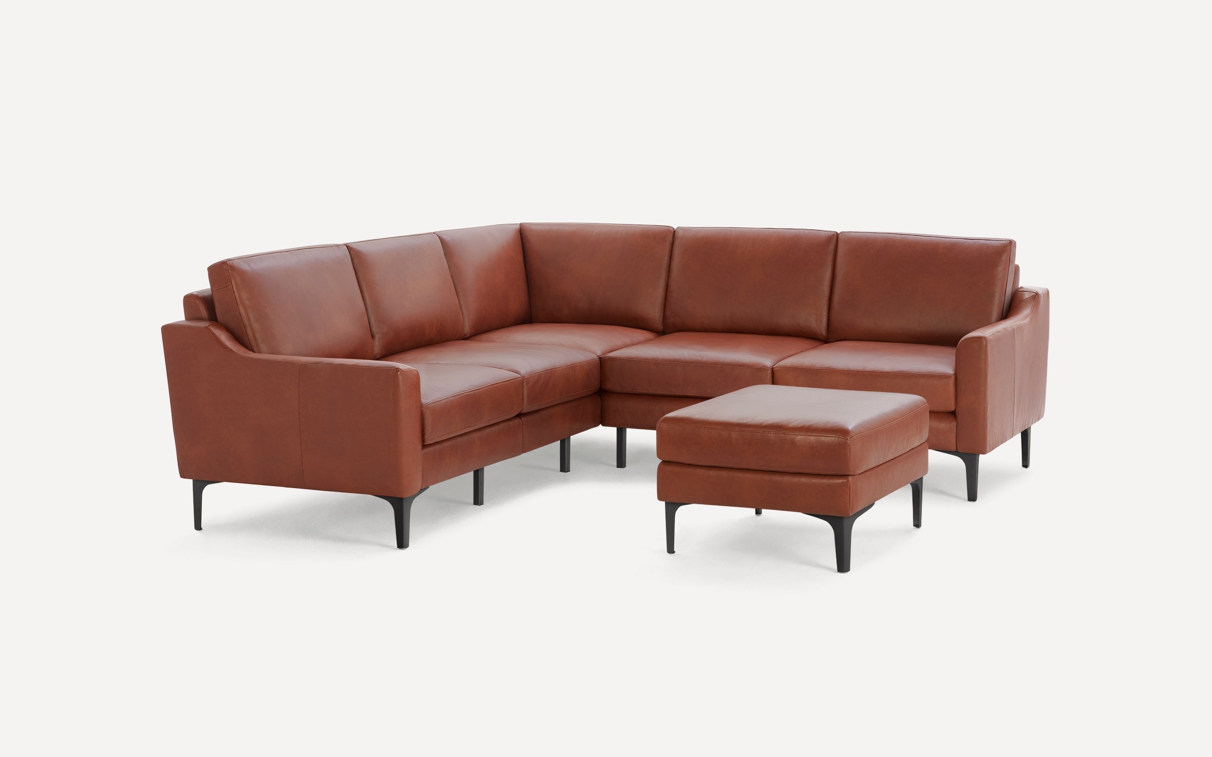 Modern brown leather sectional sofa with black legs, accompanied by a matching ottoman, set on a white background.