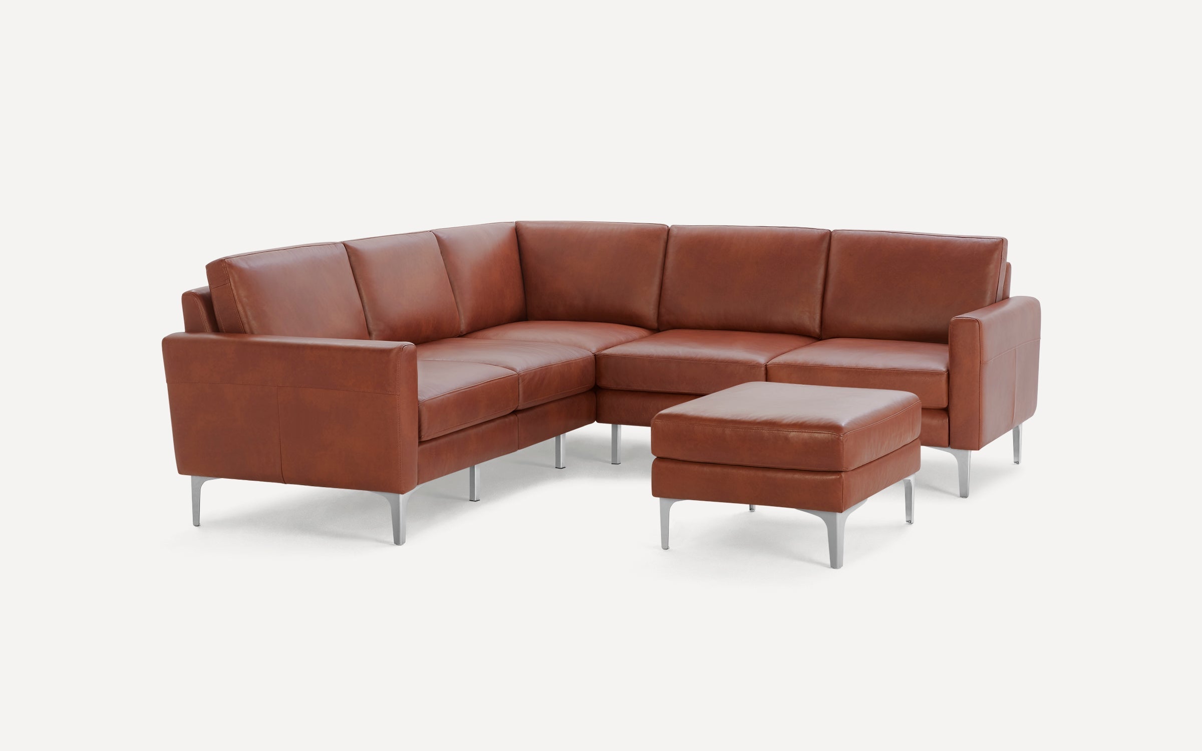Modern brown leather sectional sofa with clean lines, metal legs, and matching ottoman on a white background.