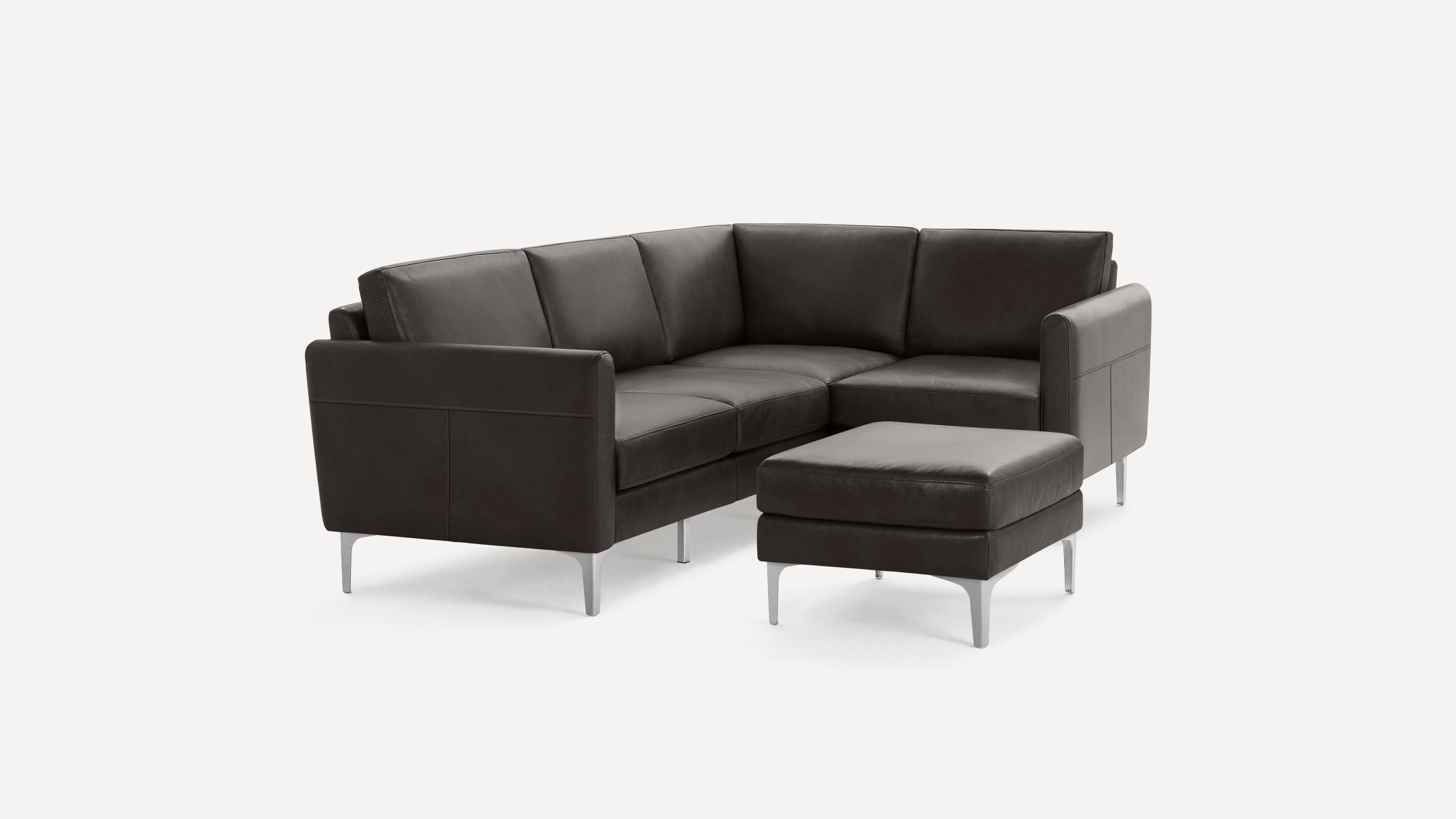 Modern dark brown leather sectional sofa with clean lines, metal legs, and a matching ottoman on a white background.