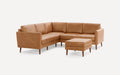 Mid-century modern tan leather sectional sofa with wooden legs and matching square ottoman on white background.