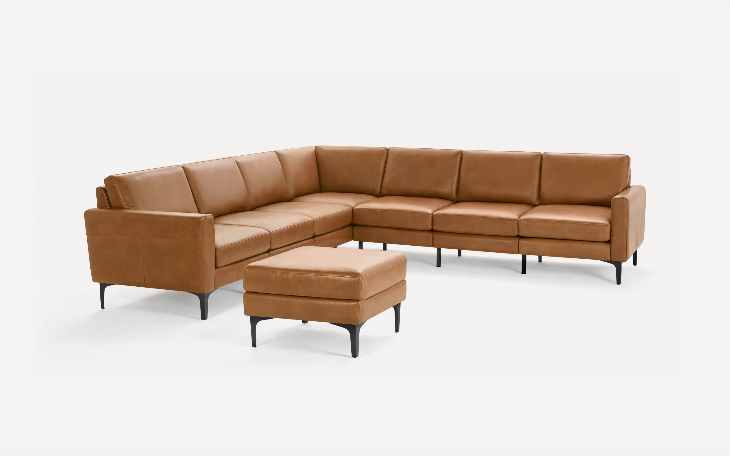Modern brown leather sectional sofa with clean lines and black tapered legs, paired with a matching square ottoman.