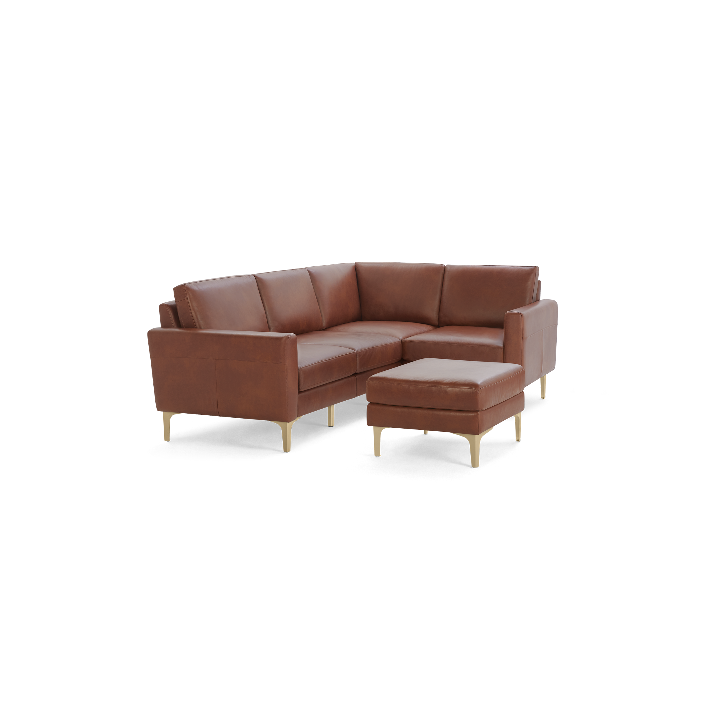 Brown leather L-shaped sectional sofa with matching ottoman, supported by light wooden legs, against a black background.