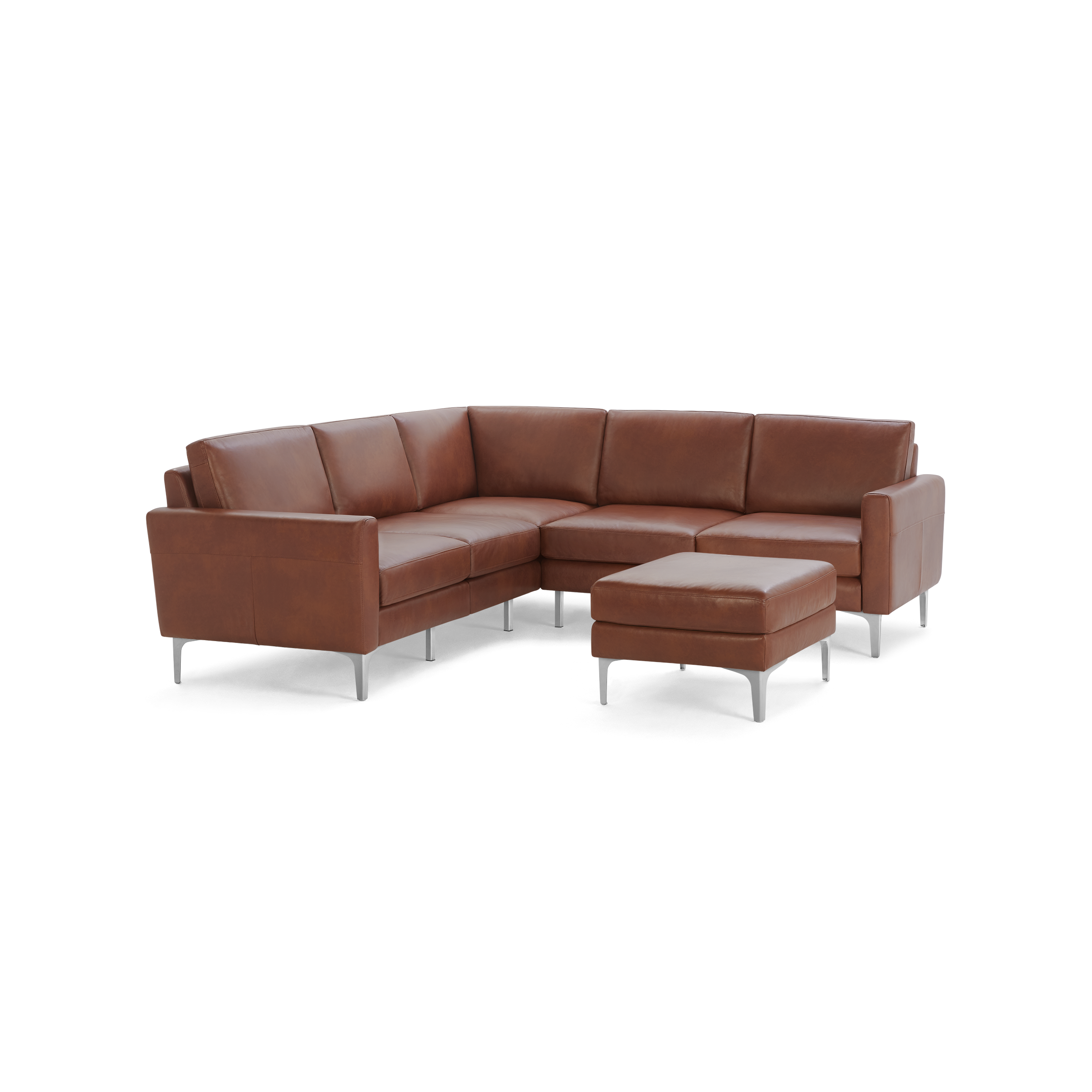 Modern brown leather L-shaped sectional sofa with matching ottoman and sleek metal legs, isolated on black background.