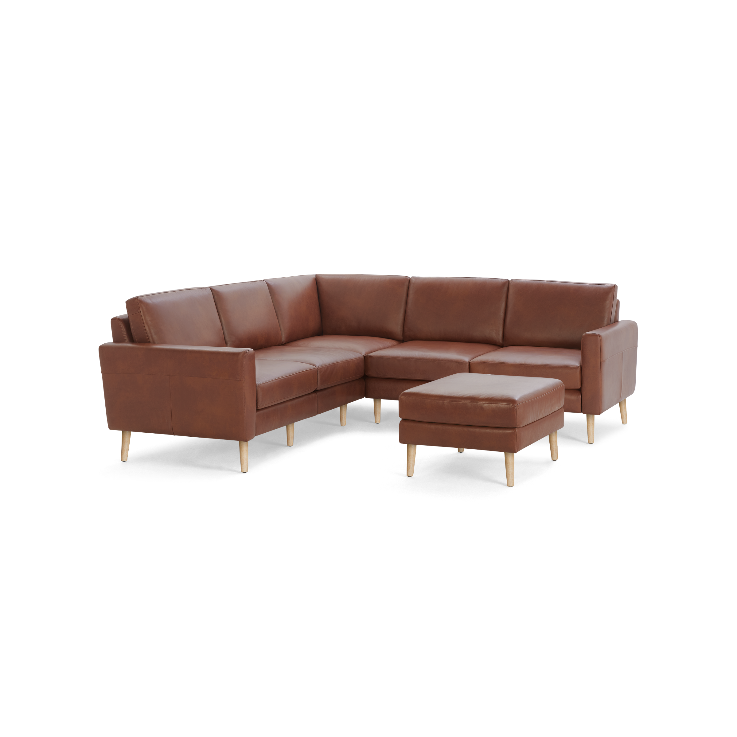 Brown leather L-shaped sectional sofa with wooden legs and matching ottoman, modern design, spacious seating.