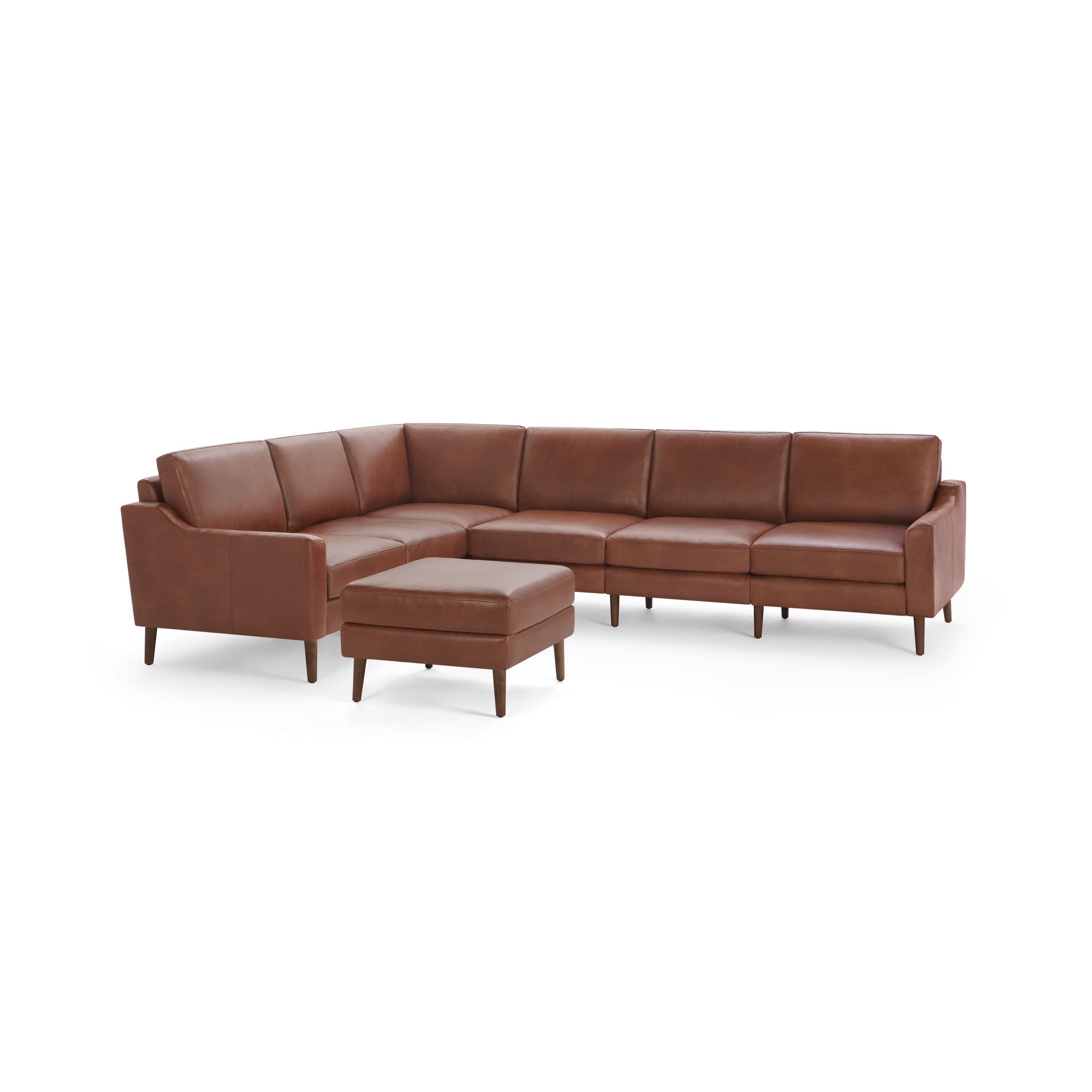 Brown leather L-shaped sectional sofa with a matching square ottoman, supported by wooden legs, showcasing a modern design.