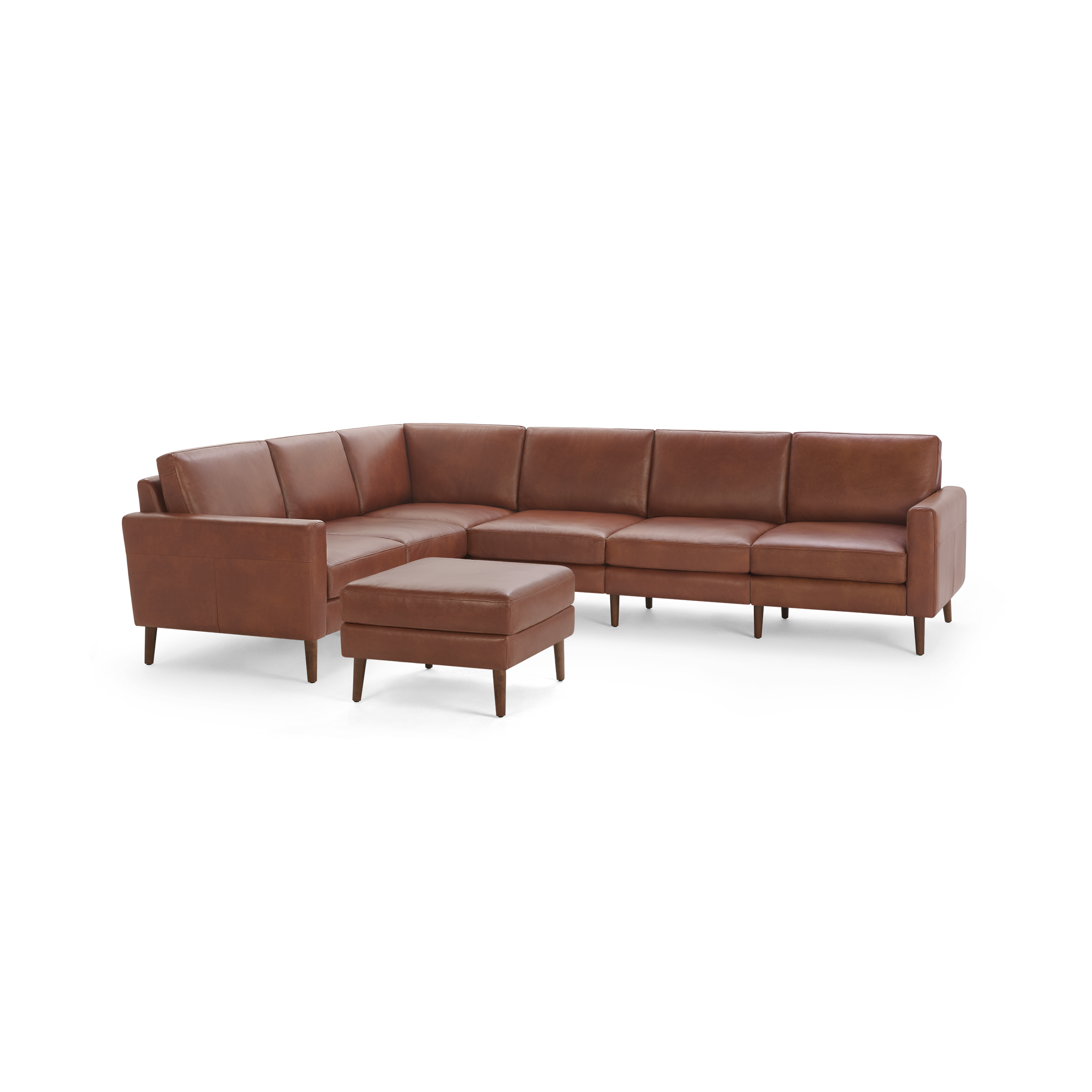 Brown leather L-shaped sectional sofa with wooden legs and matching ottoman, modern and minimalist design.