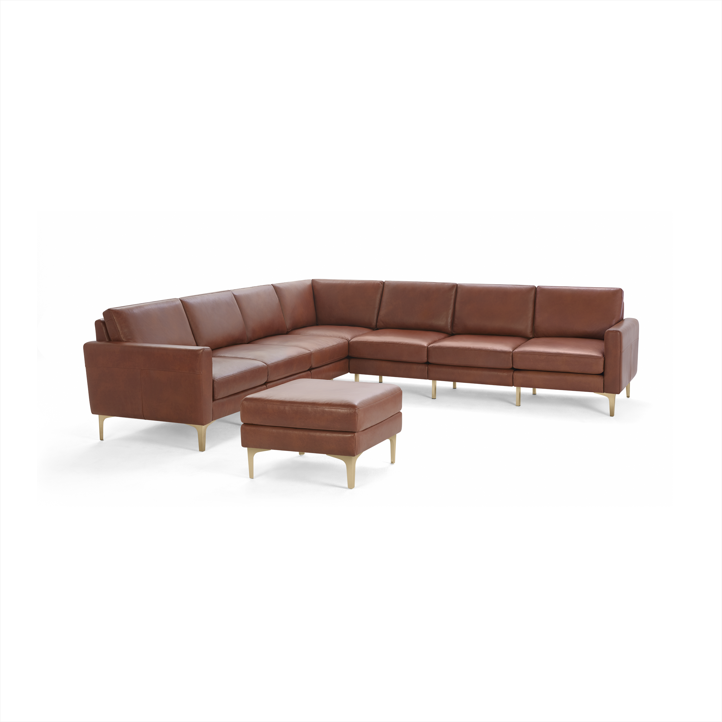 Brown leather L-shaped sectional sofa with matching ottoman, metal legs, and cushioned seating for modern living spaces.