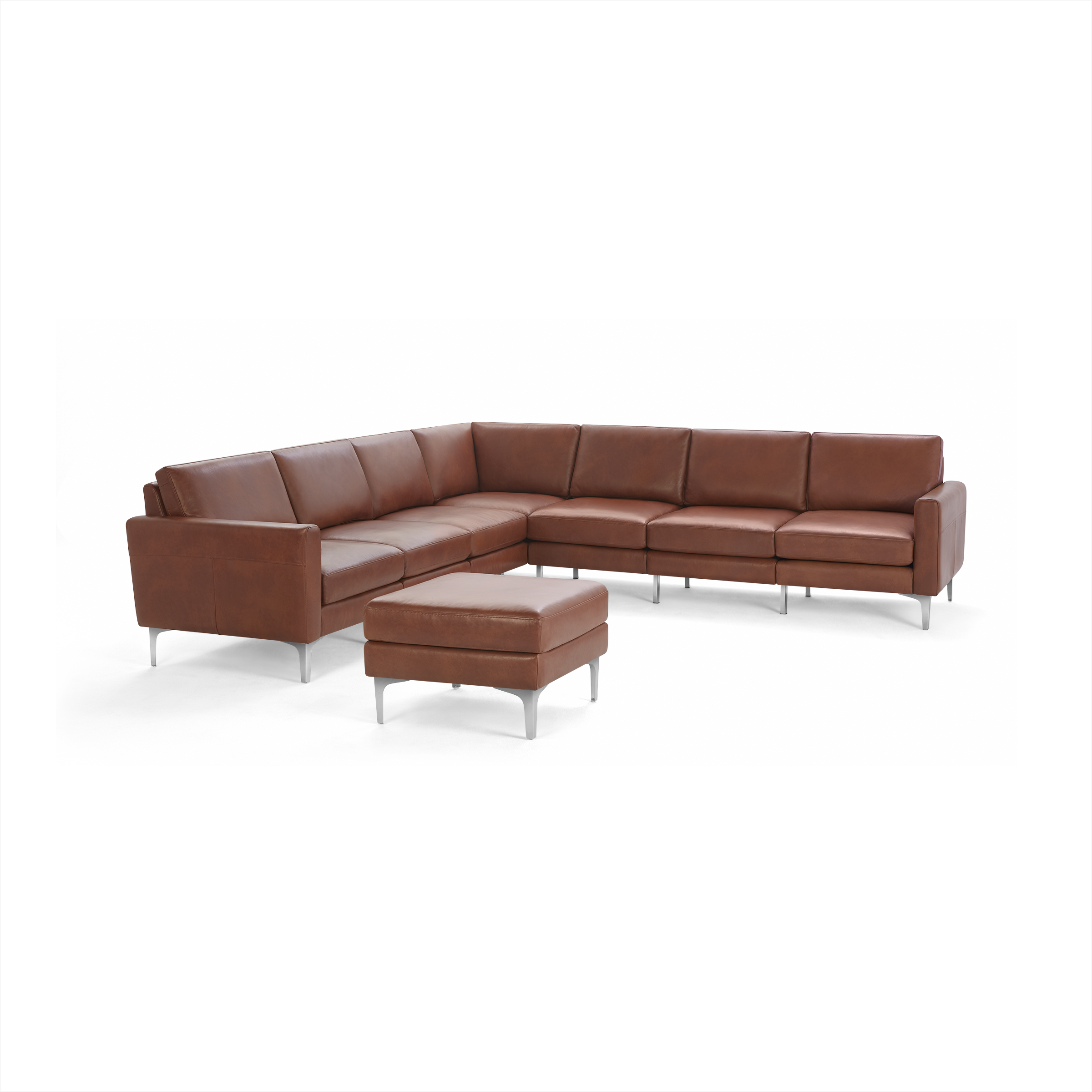 Large brown leather sectional sofa with clean lines and a matching ottoman, supported by sleek metal legs.