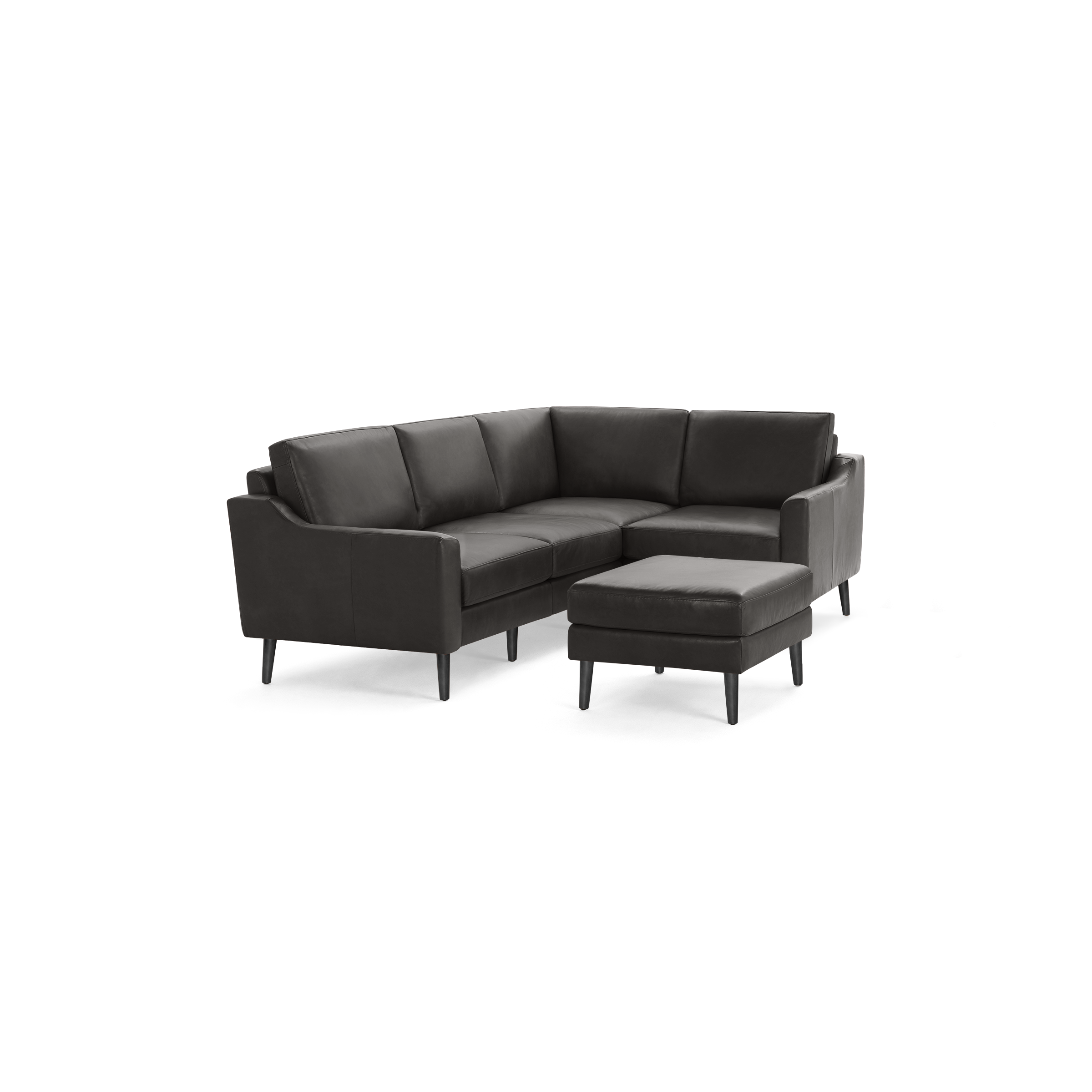 Modern dark gray L-shaped sectional sofa with sleek low arms, cushioned seats, angled backrests, and matching ottoman on wooden legs.