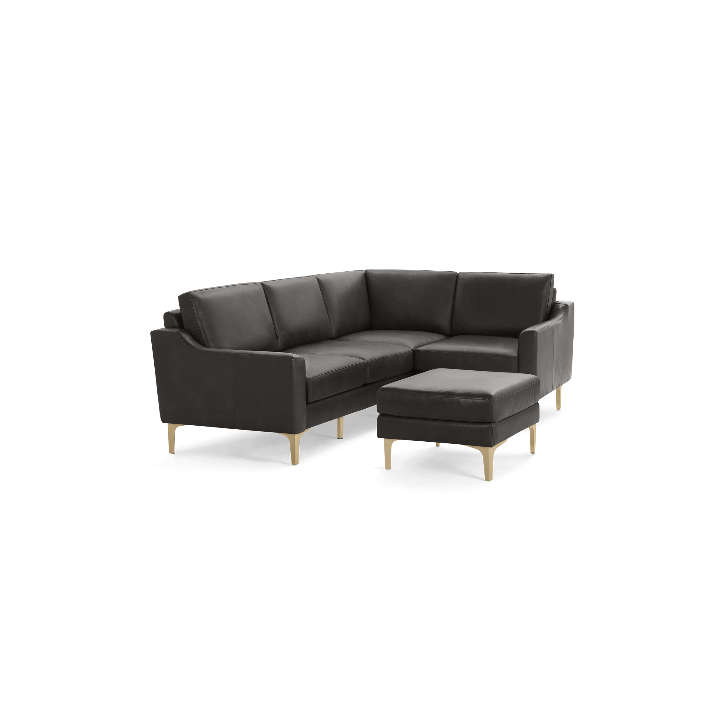 Dark gray leather L-shaped sectional sofa with wooden legs and matching ottoman isolated on black background.