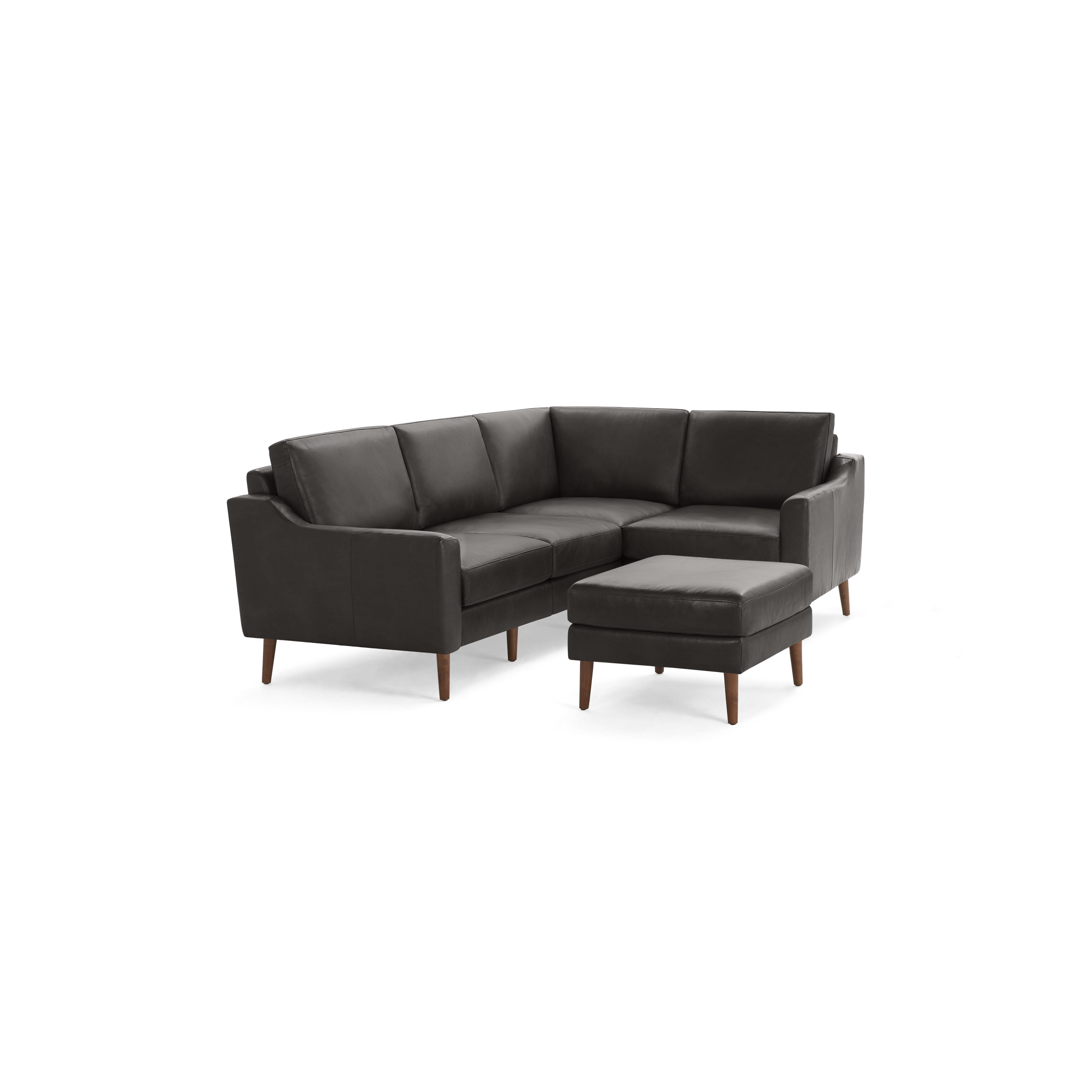 Dark gray leather L-shaped sectional sofa with wooden legs and matching ottoman, modern minimalist design.