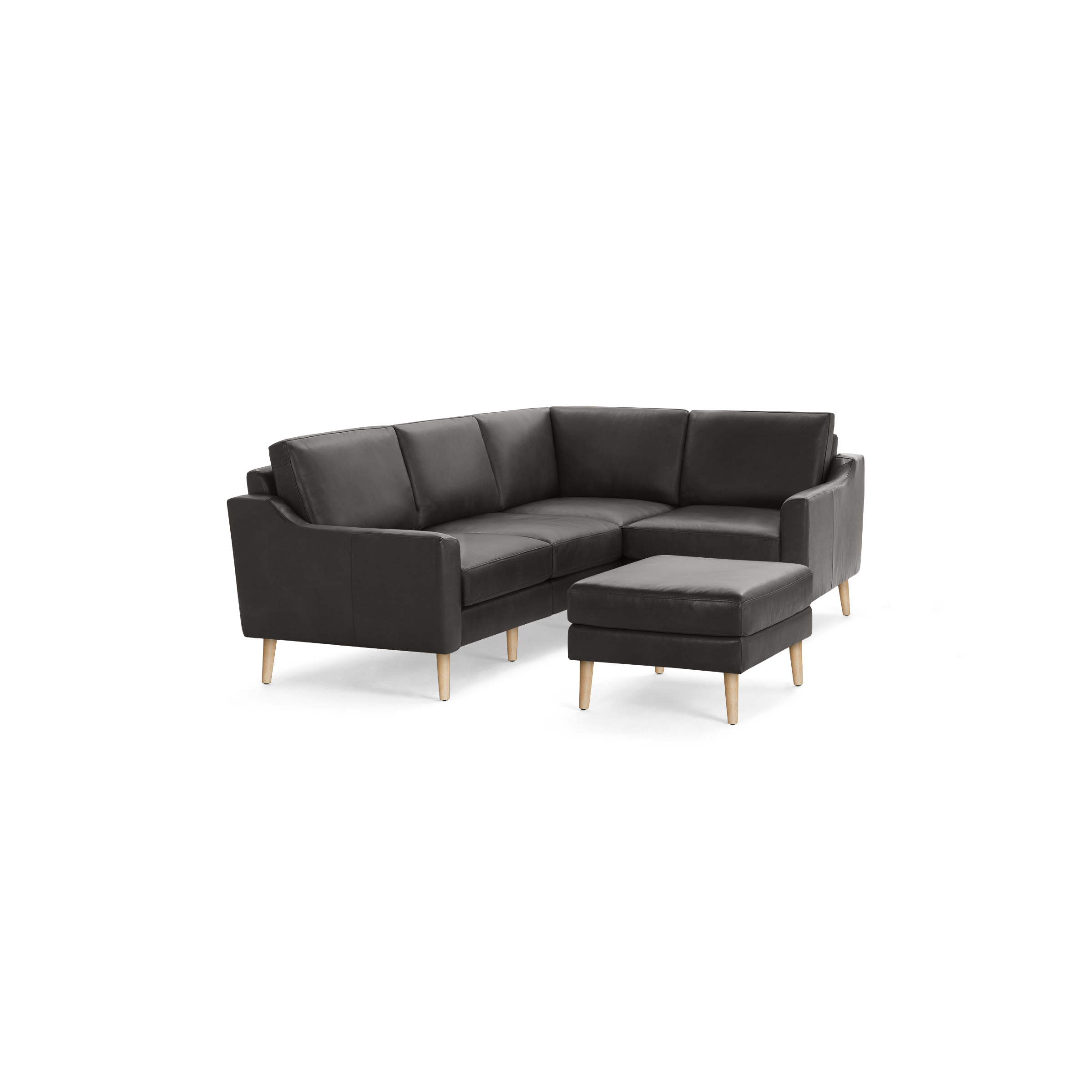 Modern dark gray leather sectional sofa with clean lines, wooden legs, and matching ottoman on black background.