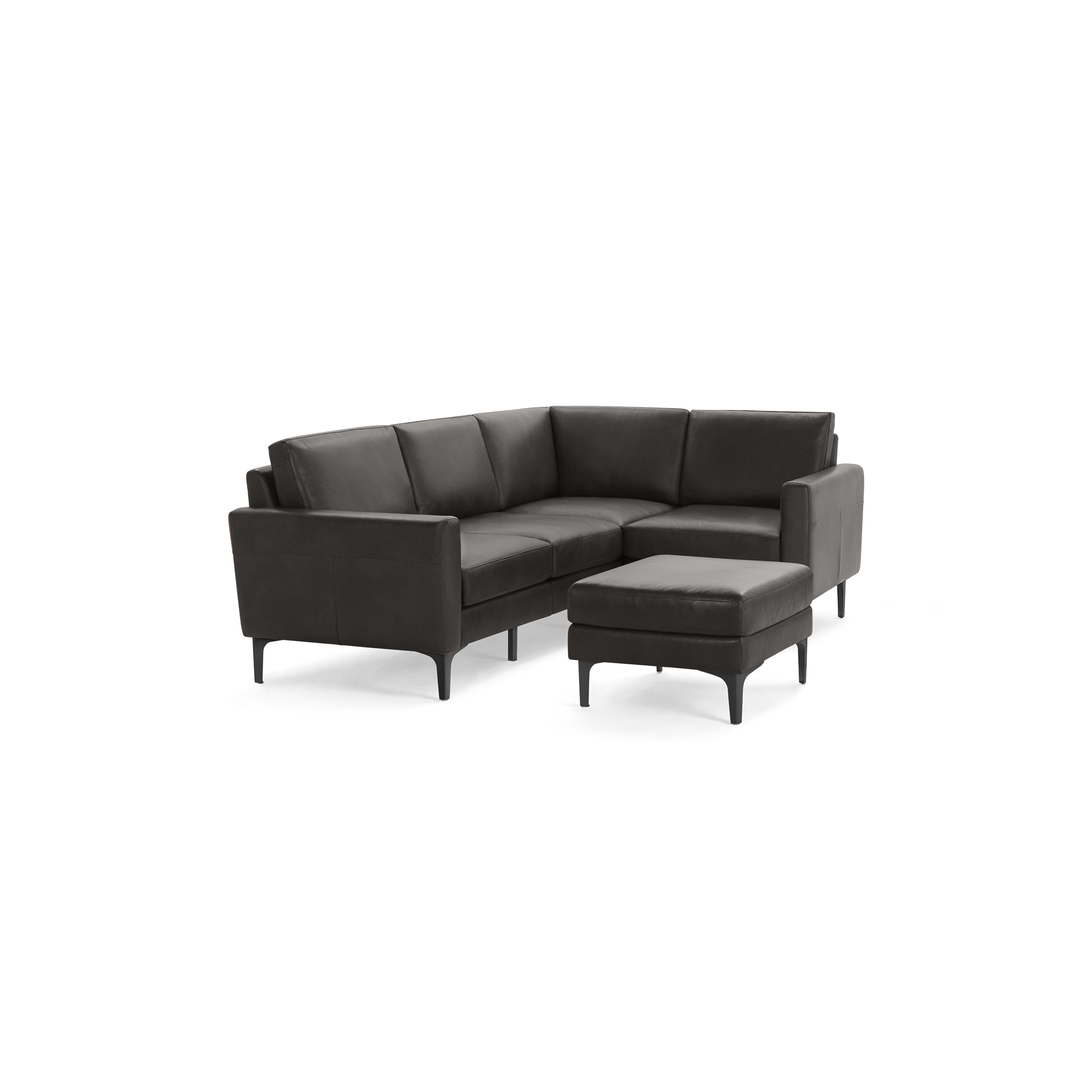 Modern dark gray leather L-shaped sectional sofa with three seat cushions and a matching ottoman on black legs.