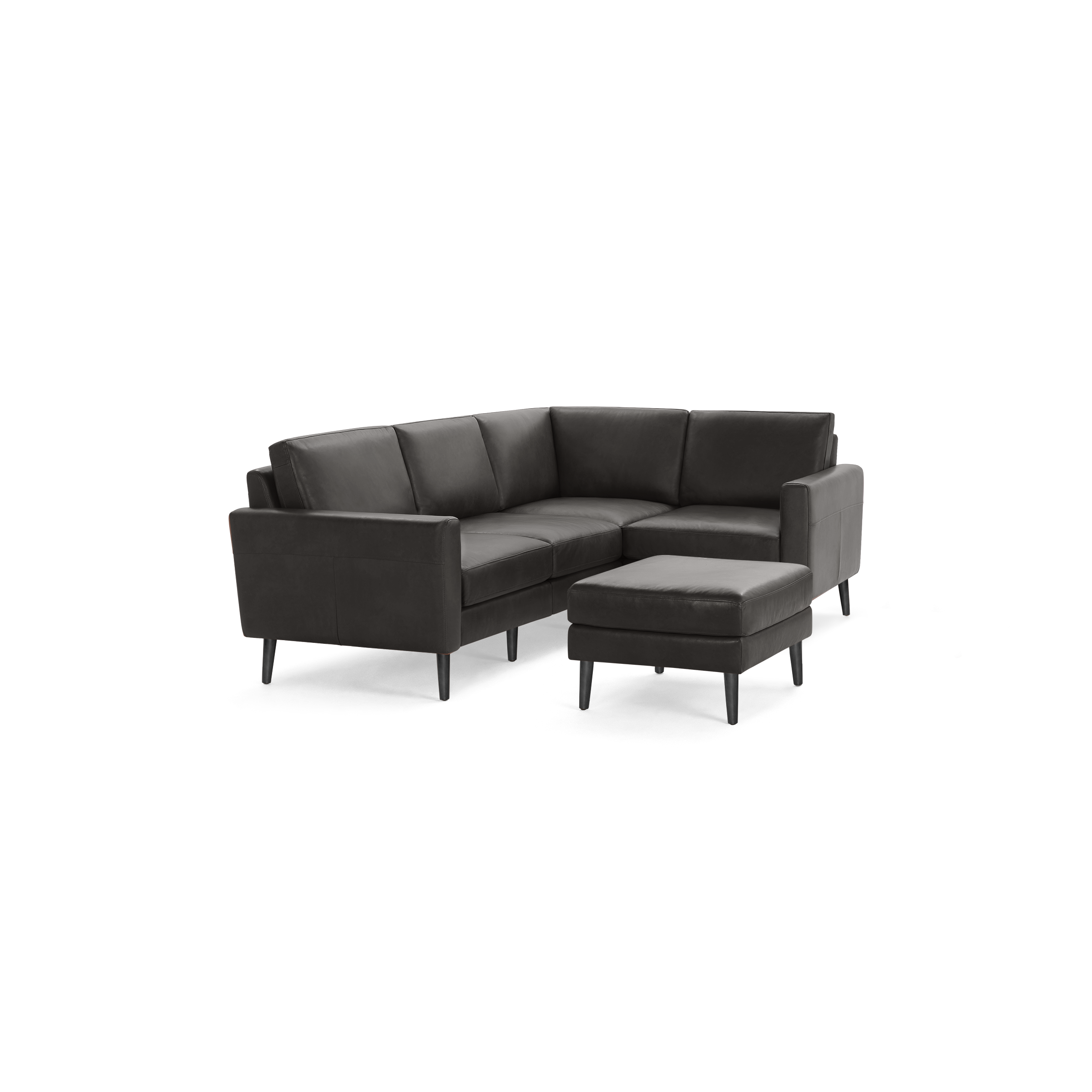 Dark gray L-shaped leather sectional sofa with a matching ottoman, featuring clean lines and slender black legs.