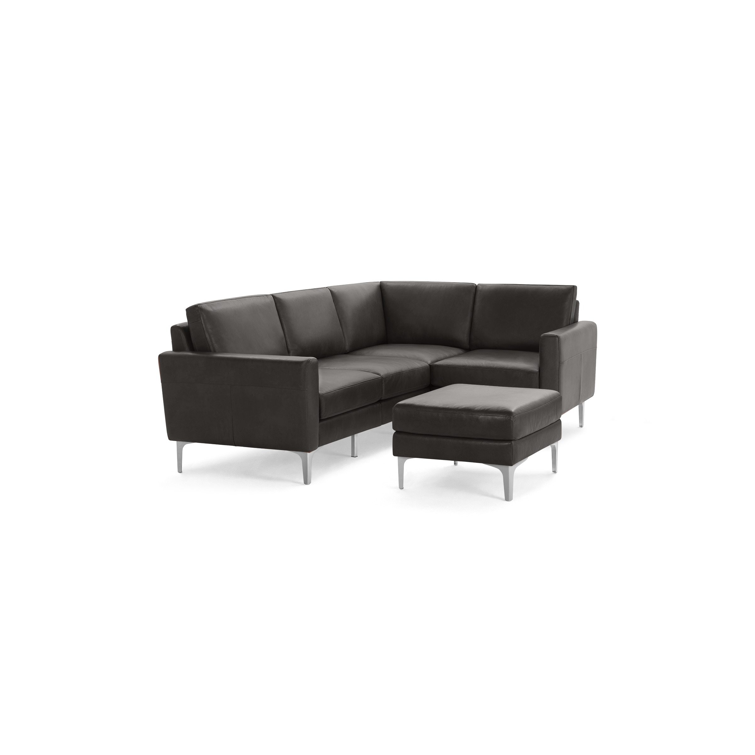 Modern dark gray leather L-shaped sectional sofa with metal legs and matching ottoman on black background.