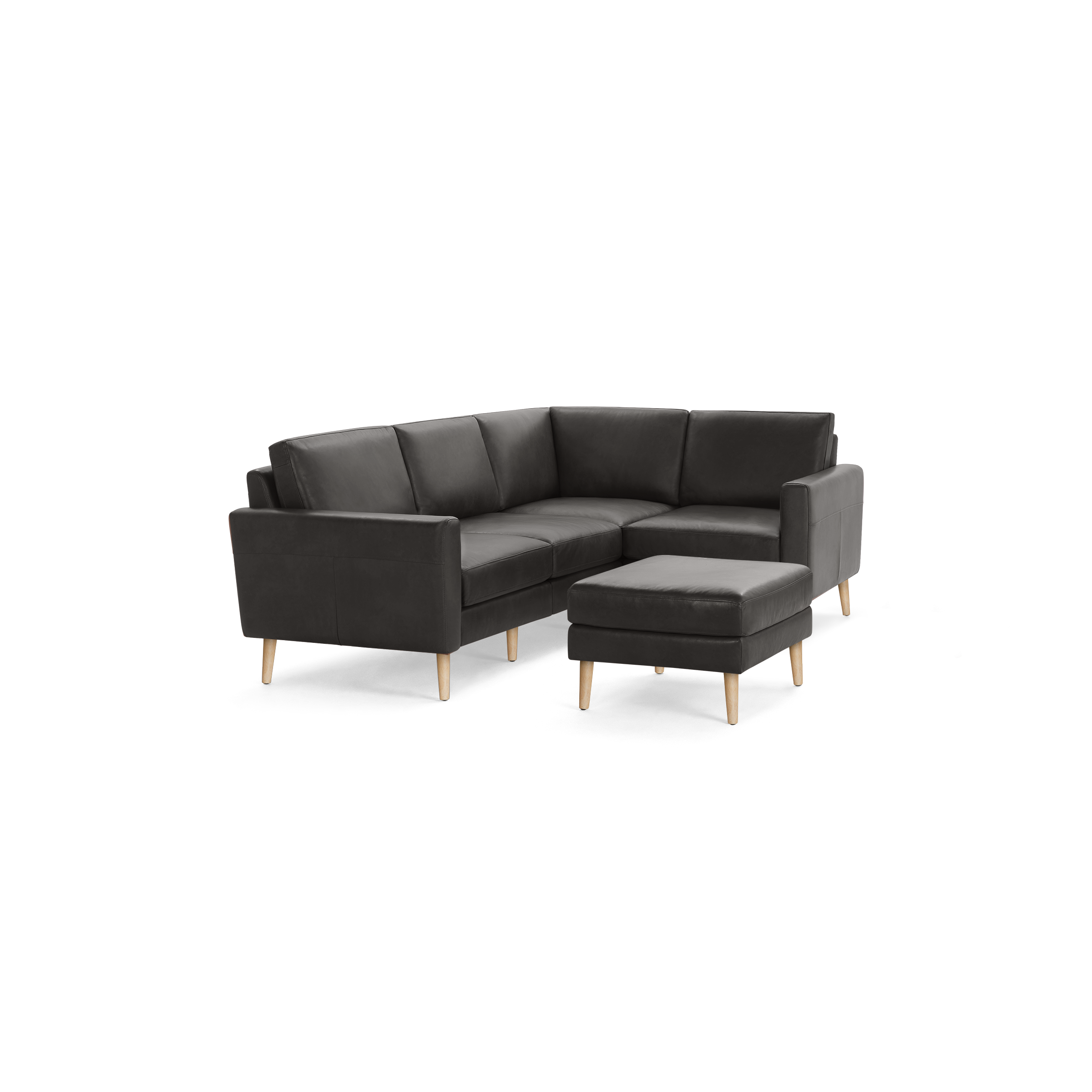 Modern dark gray leather sectional sofa with wooden legs and matching ottoman, featuring clean lines and cushions.